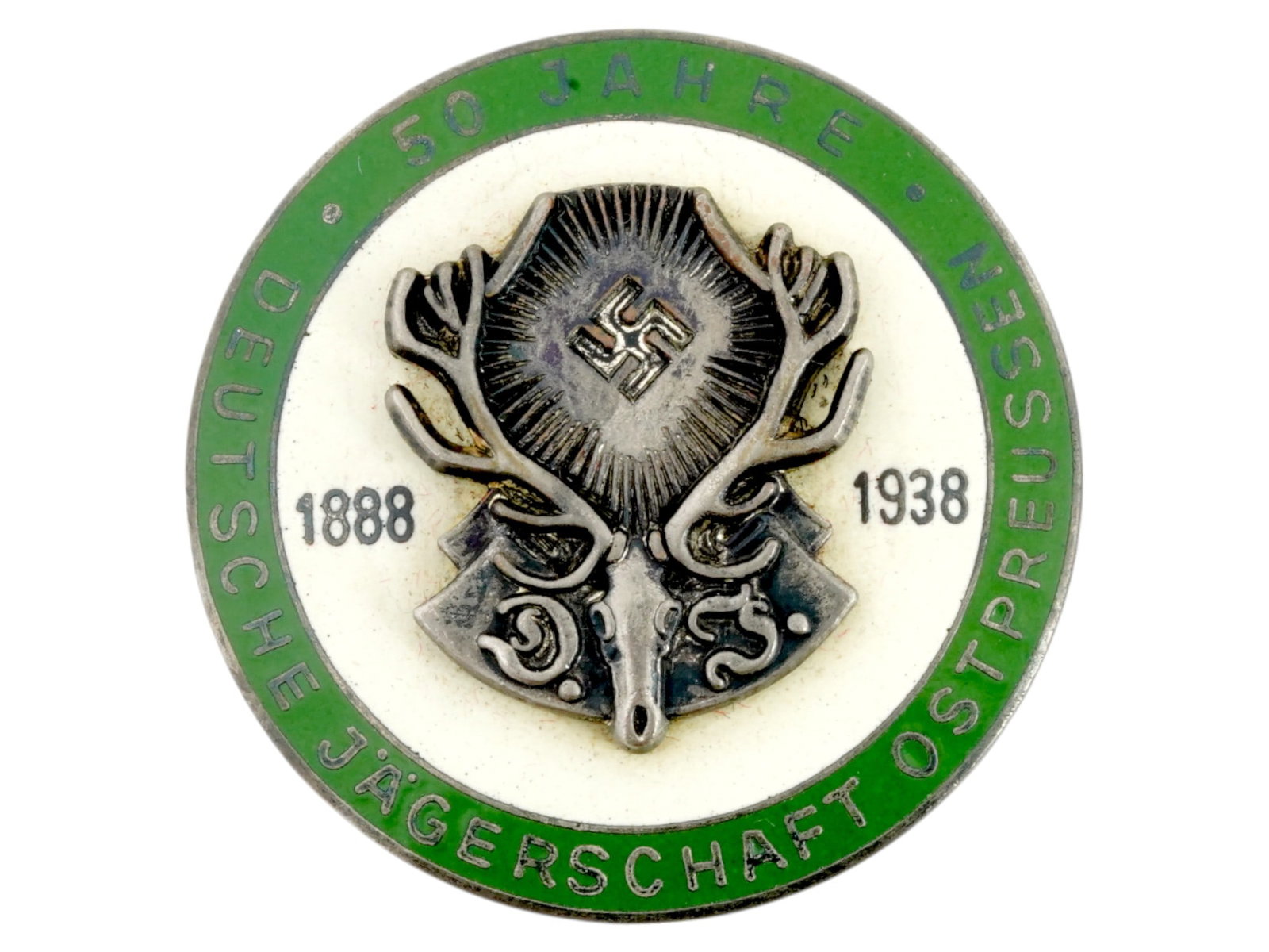 GERMAN WWII TYPE 50 YEARS TO HUNTING SOCIETY BADGE: A WWII Nazi German Third Reich type 50th Anniversary Commemorative shield of the German Hunting Association of East Prussia with an antlered skull and swastika insignia used by the association during 