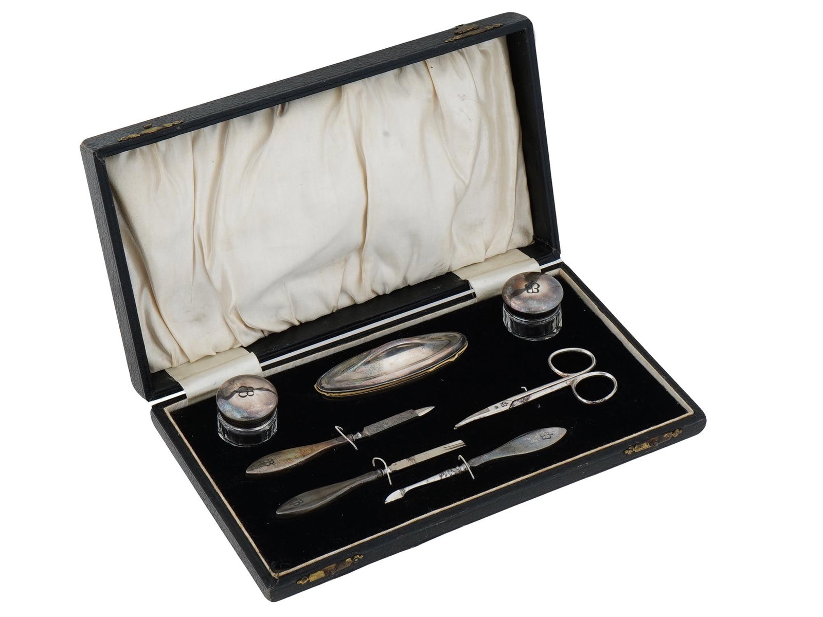 SILVER MANICURE SET USED TO BELONG TO EVA BRAUN: A WWII Nazi German type Silver manicure set consisting of seven utensils and a powder pad. All pieces are marked with the initials EB which allow to say that they used to belong to Eva Braun. Probably