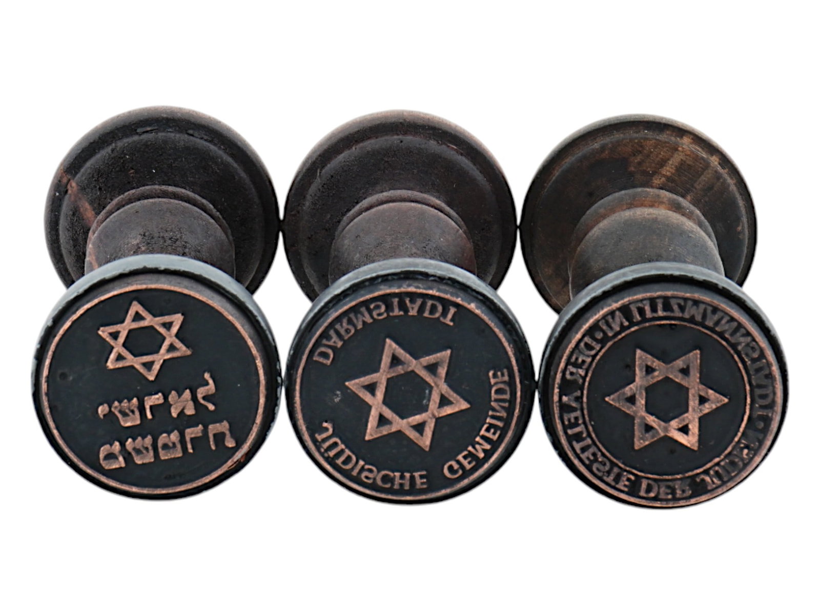 WWII TYPE JEWISH GHETTO ADMINISTRATION HAND STAMPS: A lot of three World War II model wooden hand stamps of ghetto administrations. Der Aelteste der Juden in Litzmannstadt, Council of Elders of the Jewish Ghetto in Lodz. Darmstadt Judische Gemeinde, Je