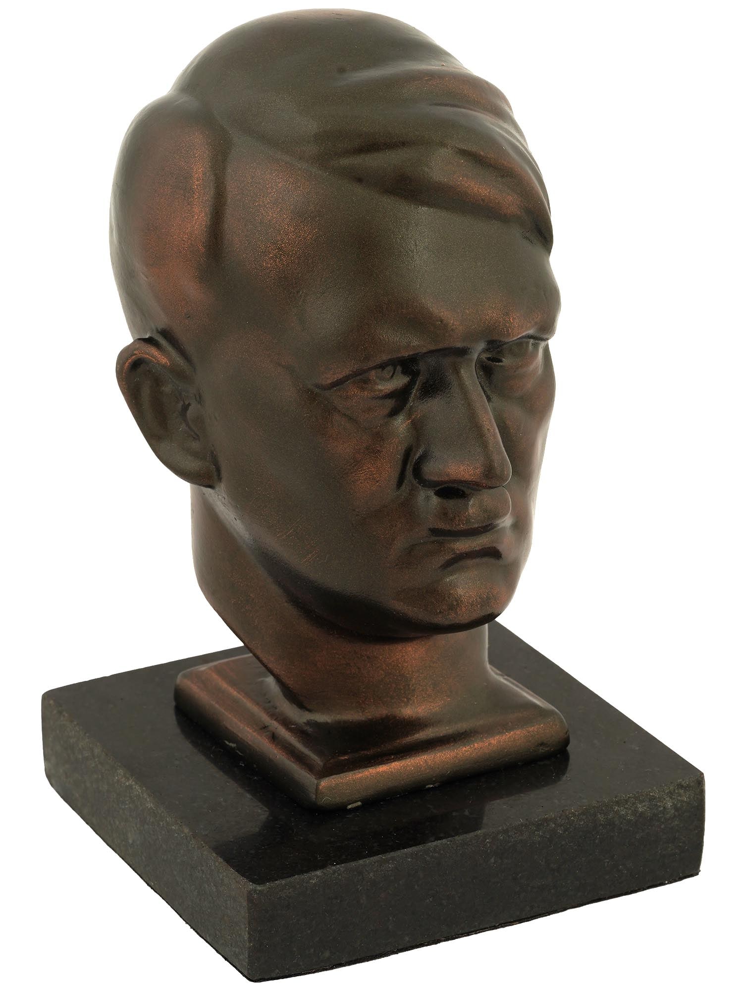 AFTER HANS RETZBACH NAZI GERMAN BUST OF ADOLF HITLER: A Nazi German cast iron bust representing Adolph Hitler. The sculpture is mounted on a carved stone base. After an original work by Hans Retzbach, 1888 to 1960, a German sculptor. Second World War Naz