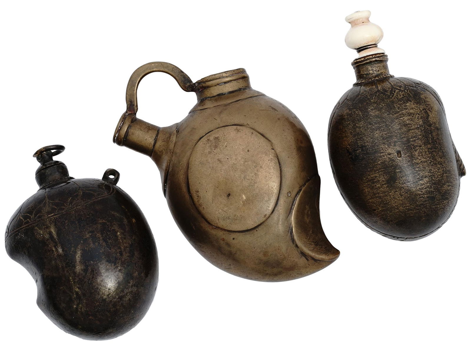 GROUP OF ANTIQUE BRONZE POWDER FLASKS HOOKAH POT: A lot of two antique hand crafted brass powder flasks and a miniature hookah pot. Circa: late 19th century. The mango shaped wares are adorned with floral, foliage, and geometrical ornaments. A pair o