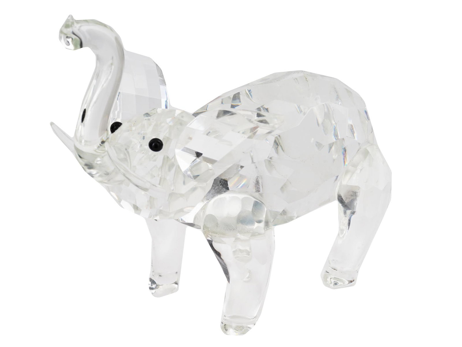 MINIATURE SWAROVSKI CRYSTAL ELEPHANT FIGURINE: A miniature Swarovski faceted crystal figurine. The figurine is modeled as a baby elephant. Unmarked. Circa: the second half of the 20th century. Swarovski AG is an Austrian company specializing in th