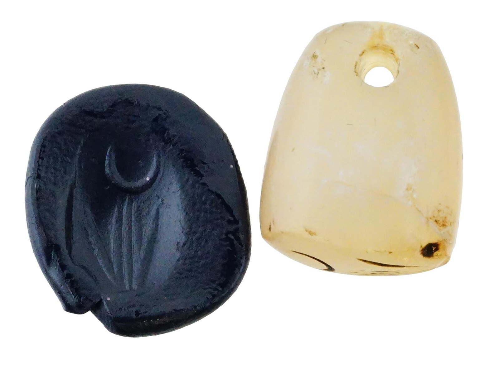 ANCIENT FLORAL HAND CARVED HARD STONE SEAL PENDANT: An ancient hand carved probably Agate stone seal pendant. The imprint depicts a foliage design. An opening on the upper part. This seal, meticulously carved with intricate designs and motifs, served a