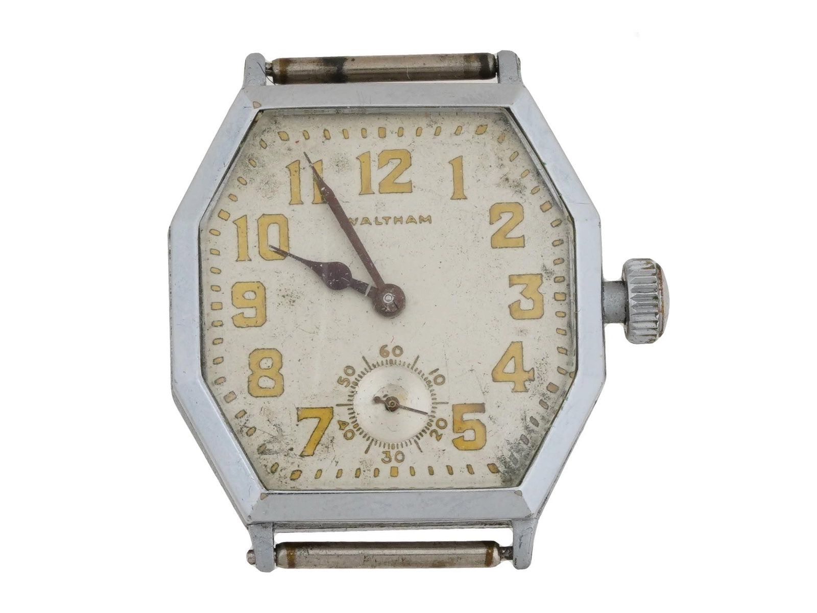 VINTAGE WATCH FACE BY WALTHAM WATCH CO: A vintage octagonal shaped watch face from wristwatch by Waltham Watch Co., a manufacture active between 1850 and 1957. The watch face is cream colored, and features large, Arabic numerals in a gold t