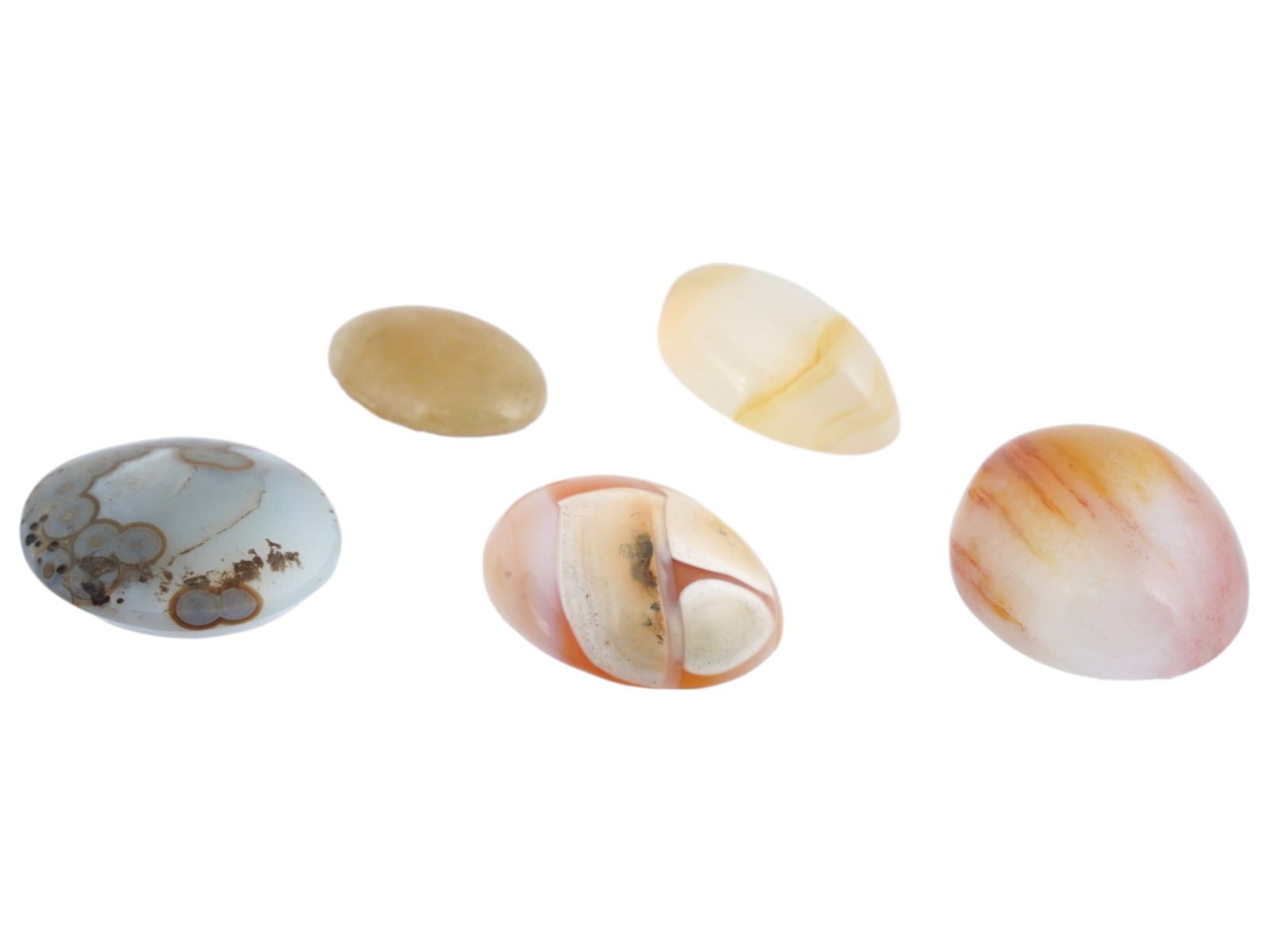 COLLECTION OF FIVE BANDED AGATE CABOCHON STONES: A collection of five hand carved banded Agate cabochon in various sizes. The oval shaped cabochon are white, orange, yellow and grey. Carved Gemstones, Fine Jewelry And Decorative Collectibles. Dimens