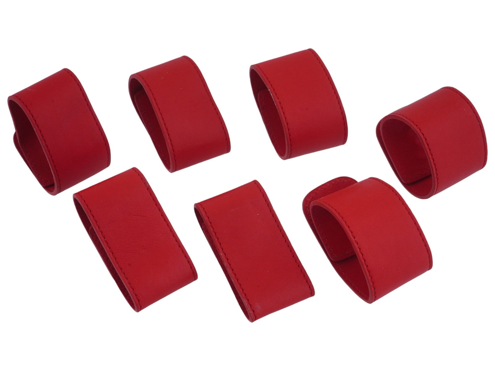 SET 7 COACH LEATHERWARE LEATHER NAPKIN HOLDERS: A set of seven Coach Leatherware genuine leather red napkin holders. Napkin holders are made of genuine leather and neatly stitched along the edges. With metal fasteners. Marked on the inside. Antique