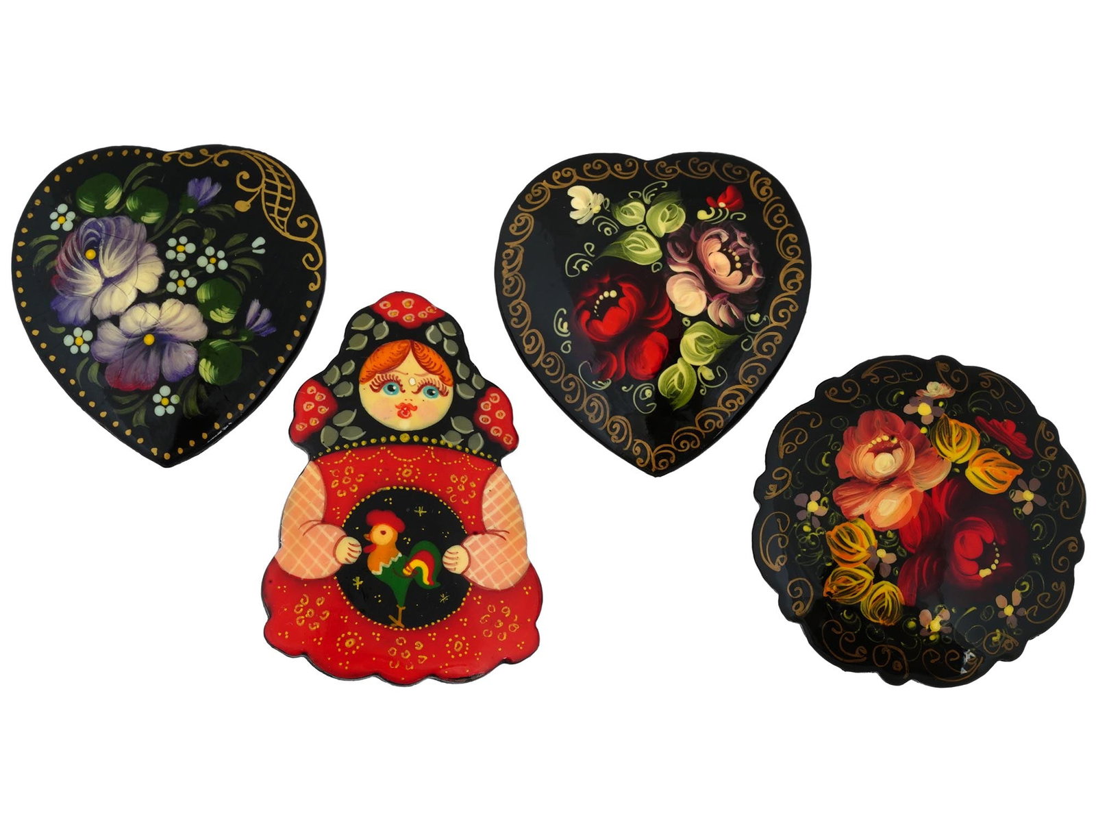 4 RUSSIAN TRADITIONAL HAND PAINTED WOODEN BADGES: A lot of four vintage Russian traditional lacquered wooden badges. Two heart shaped badges, one round, and one in the shape of a doll. Three of the four hand painted badges depict lush flowers in the 