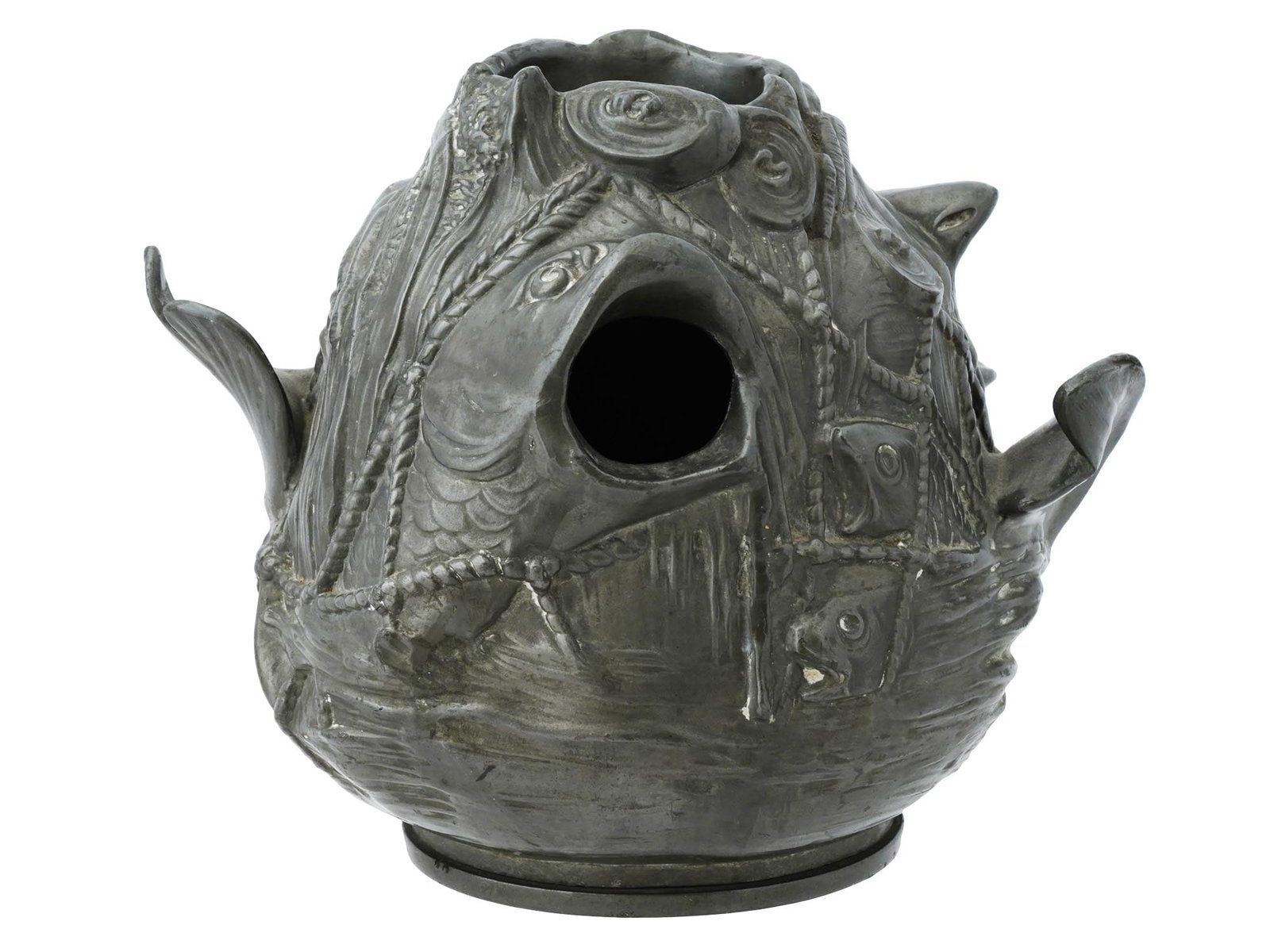 METAL AROMA LAMP SCULPTURE W FISH AND AQUATIC PATTERNS: A metal aroma lamp has a sculptural design that resembles a cluster of fish and marine elements. The surface is textured with detailed fish, ropes, and aquatic patterns, giving it a natural, underwate