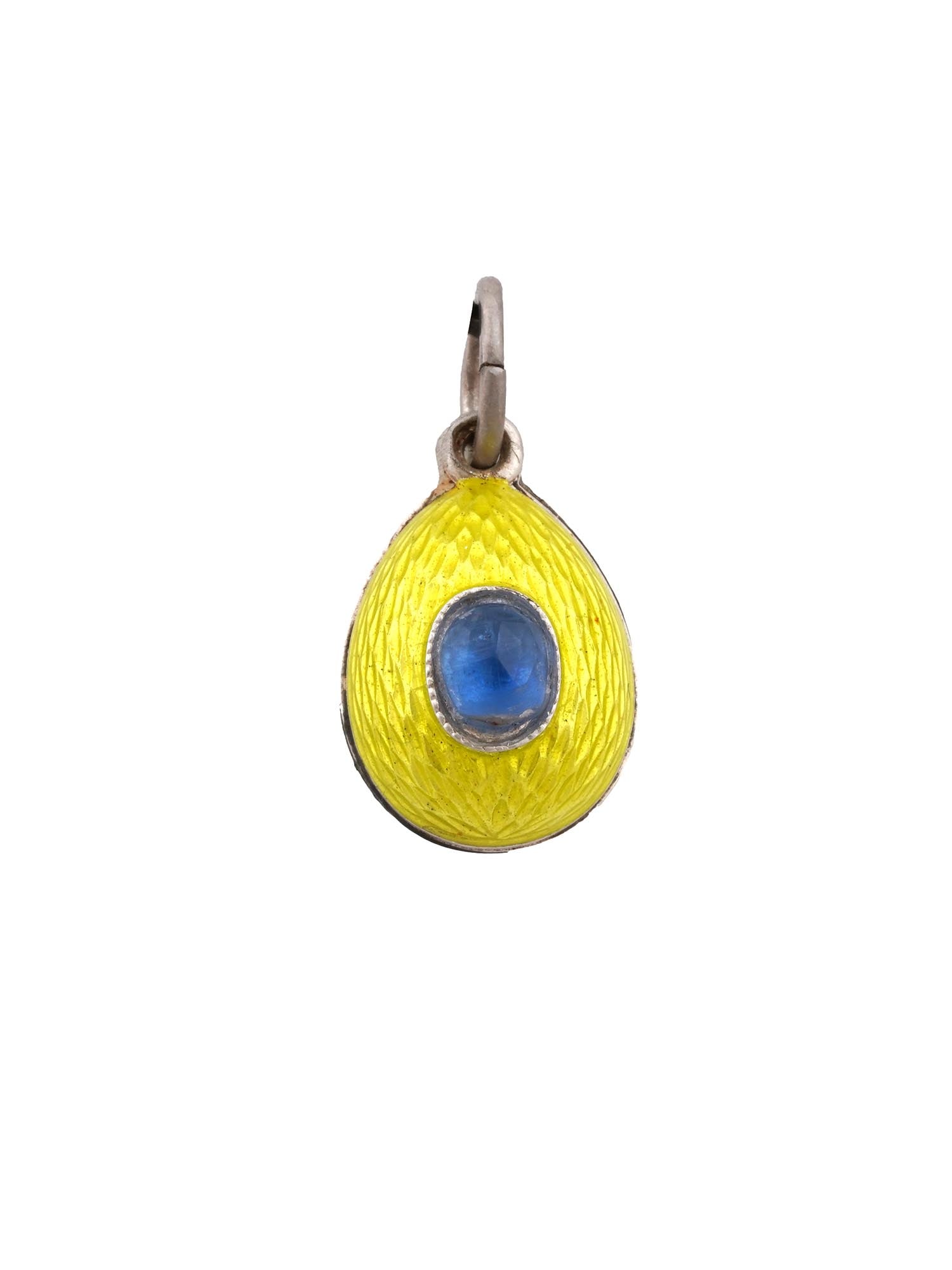 RUSSIAN SILVER ENAMEL AQUAMARINE EGG PENDANT: A Russian silver egg-shaped pendant. Yellow guilloche enamel surface. Oval-cut aquamarine stones are set on the obverse and reverse. Hallmark of 88 silver standard and makers mark are on the fitting r