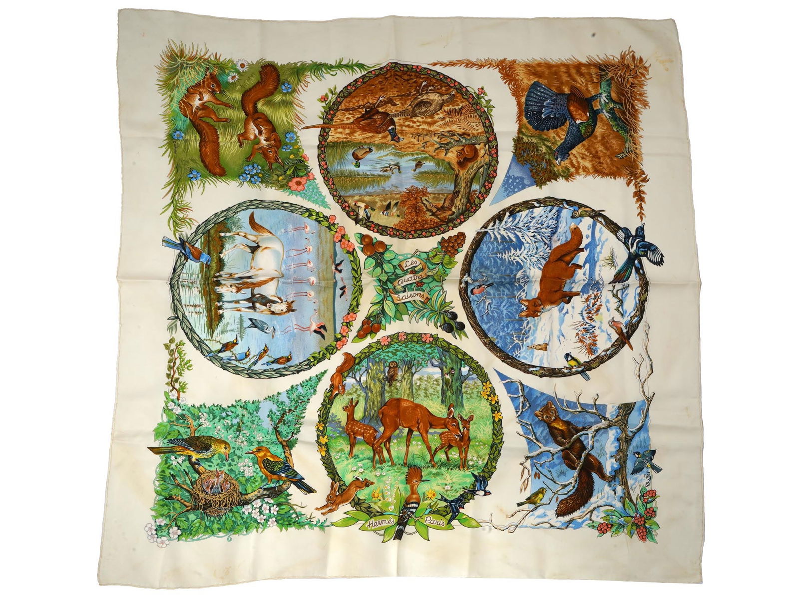 FRENCH HERMES PARIS SILK SCARF BY ROBERT DALLET: A vintage French Hermes Paris silk scarf designed by Robert Dallet, 1994. The scarf titled Les Quatre Saisons, The Four Seasons depicts the life of animals in the forest during four seasons. Marked He