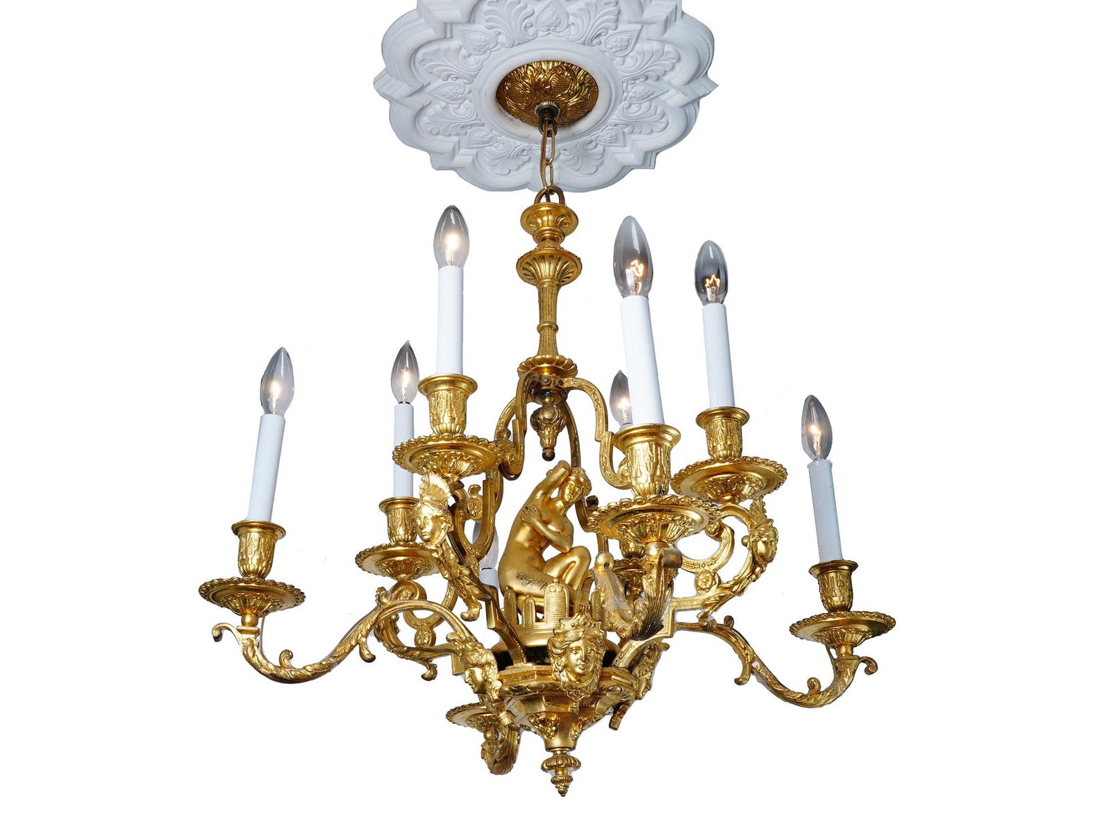ANTIQUE FRENCH BRONZE CHANDELIER AUGUSTE MOREAU: An antique French Louis XV style gilt bronze chandelier. Features eight gracefully curving arms adorned with intricate motifs, reflecting the elegant design of the era and supporting candle-style ligh