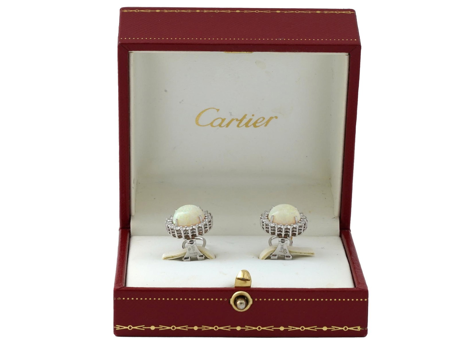 CARTIER 18K WHITE GOLD OPAL DIAMOND EARRINGS IOB: A pair of vintage 18K white gold French clip earrings by Cartier. Central white opal cabochons are encompassed with diamonds. Hallmark Cartier, 18K is on the backing. Total Weight: 9.1 grams. The earr