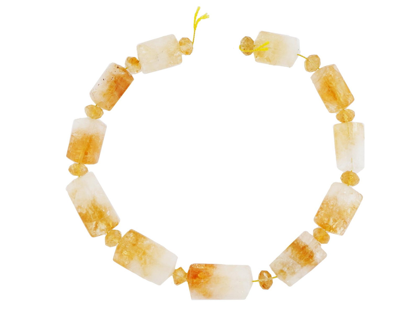 CITRINE STONE BEADS OF ELONGATED SHAPE FOR NECKLACE: A set of citrine stone beads in an elongated shape, strung on a cord with smaller faceted beads interspersed throughout, perfect for crafting into a necklace. The warm, golden hues of the citrine ston