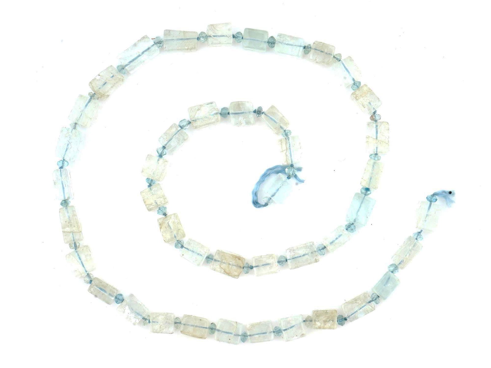 AQUAMARINE STONE BEADS CUT INTO CUBES FOR NECKLACE: A set of aquamarine stone beads cut into elegant cubes, each separated by smaller spherical beads, strung on a cord and ready to be crafted into a unique necklace. Natural Stones For Jewelry Makers An