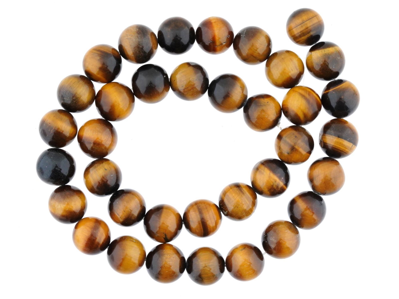 VINTAGE TIGERS EYE GEMSTONE BEADS: A lot of vintage tigers eye stone beads on a thread. Polished round beads. A total of 36 pieces. Mineral Stone Jewelry And Accessories. Dimensions: L 16 in. All measurements are approximate.