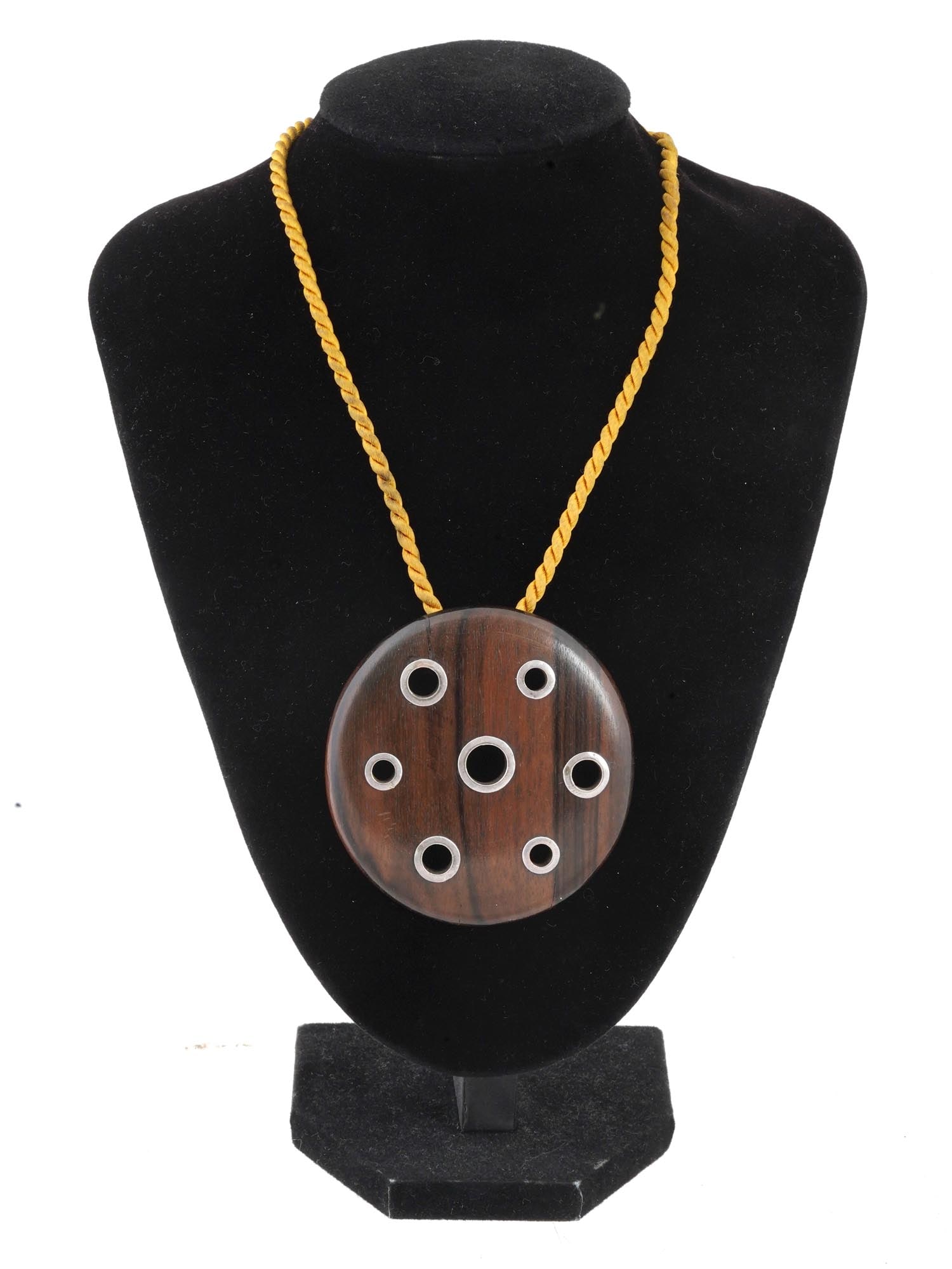 VINTAGE BOHO STERLING SILVER WOODEN DISC NECKLACE: A large vintage polished hardwood pendant. Round shape, pierced circle decor with sterling silver mounts. The item comes with a cord. Unmarked. Unusual Designer Statement Jewelry, Boho Style. Dimensio