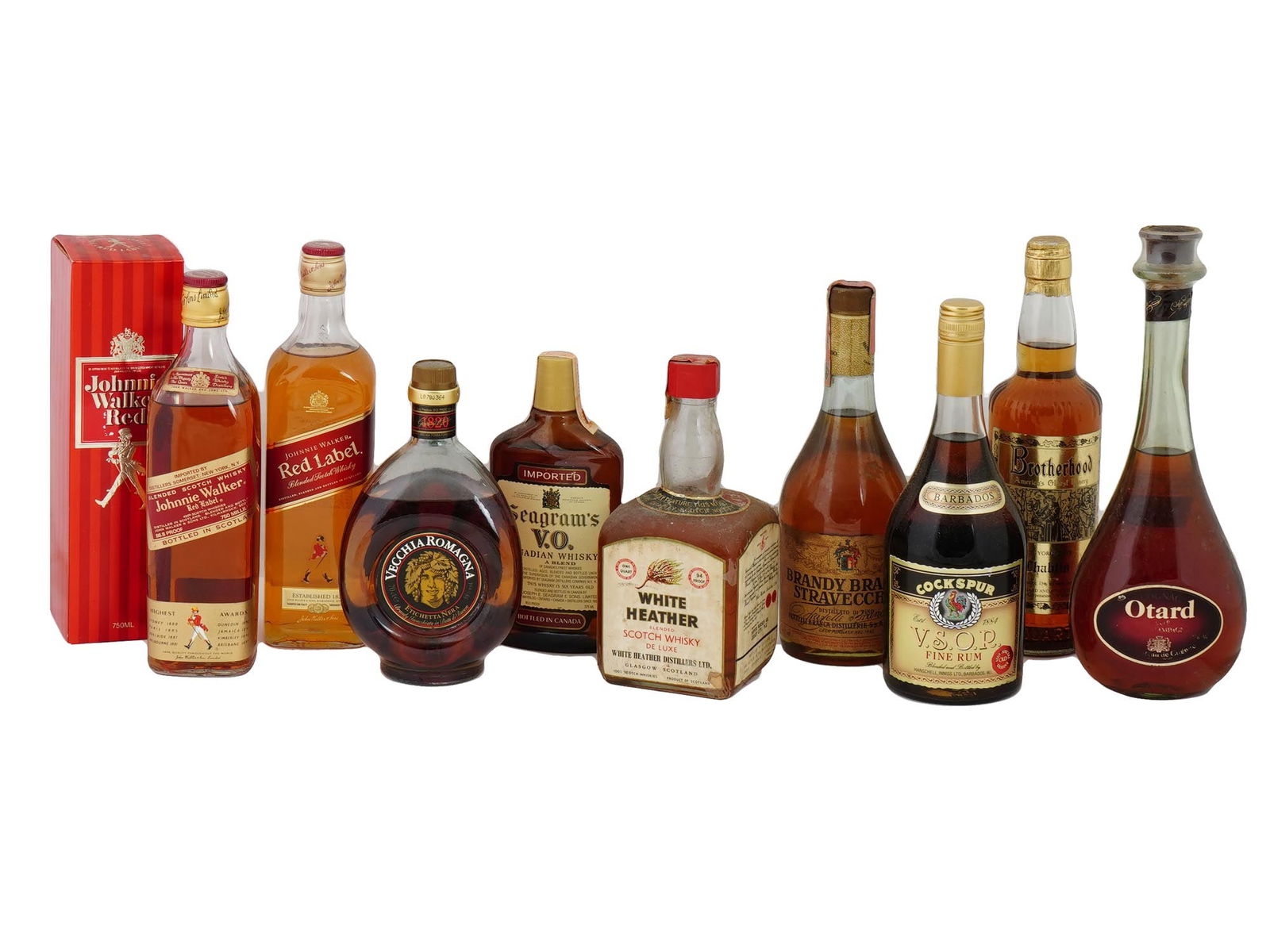 JOHNNIE WALKER SEAGRAMS COCKSPUR LIQUOR BOTTLES IOB: A lot of vintage sealed alcohol bottles. A total of 9 items. Johnnie Walker Red Label Blended Scotch Whiskey, two bottles, one in original box. Seagrams VO Canadian Blended Whiskey. White Heather Blen