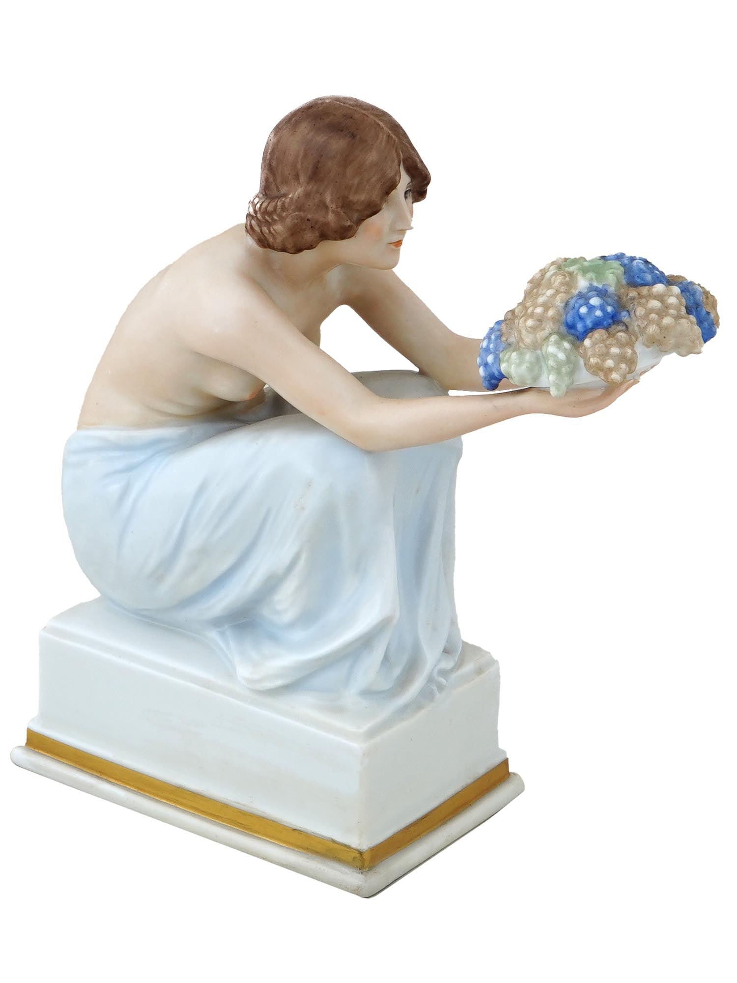 ANTIQUE GERMAN ROSENTHAL PORCELAIN MAIDEN FIGURINE: An antique German Art Deco porcelain figurine of a seated maiden holding a bowl of grapes, on a gilded box plinth. Designed by Rudolf Marcuse, German, 1878 to 1940, a sculptor. With the impressed sign