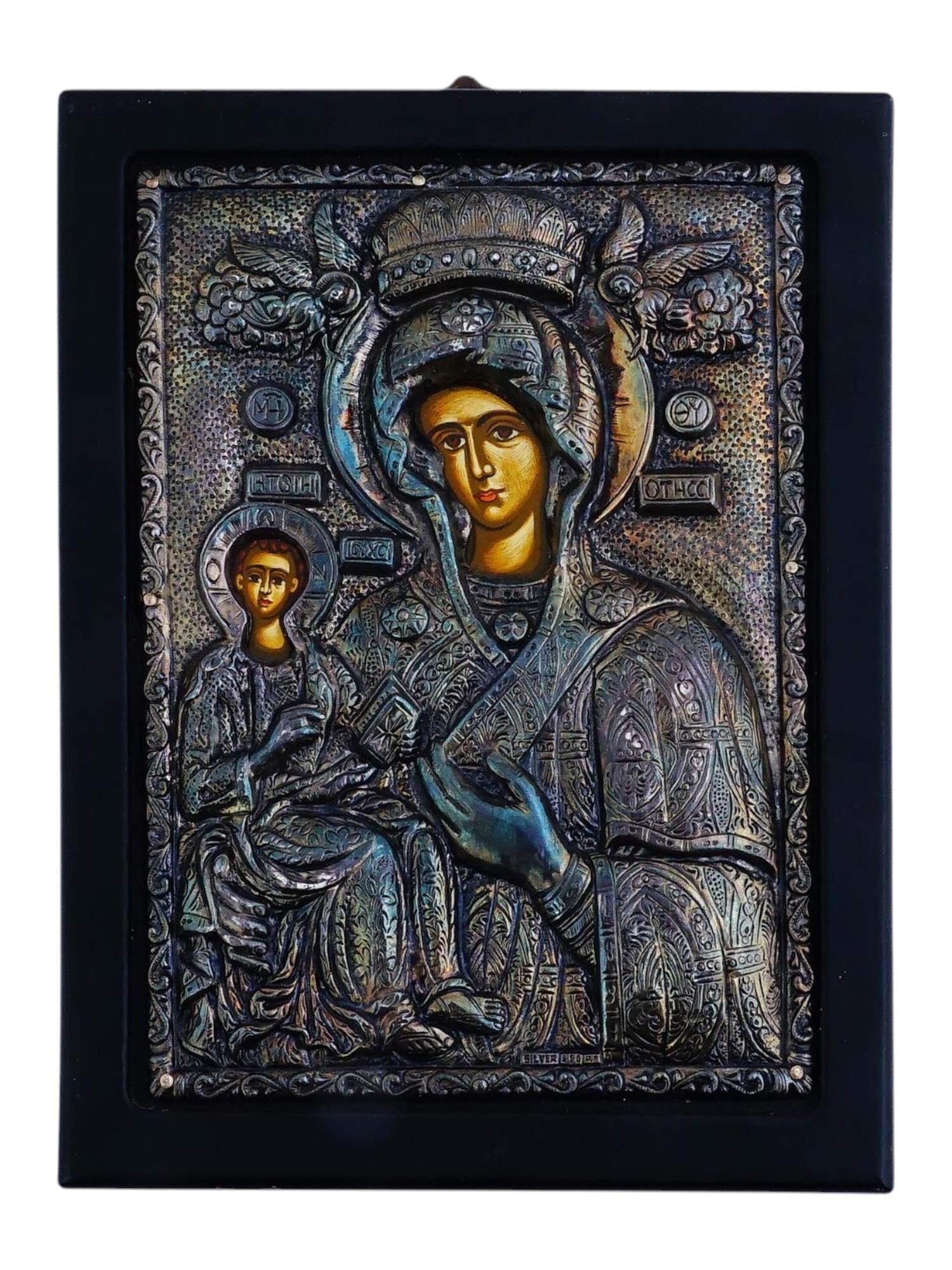 VINTAGE COPY BYZANTINE ICON MOTHER OF GOD WITH JESUS: A vintage copy of an antique Byzantine icon featuring the Mother of God holding the Infant Jesus on her left hand. The painting is executed on canvas and enhanced with a pure 950 silver oklad. With a 