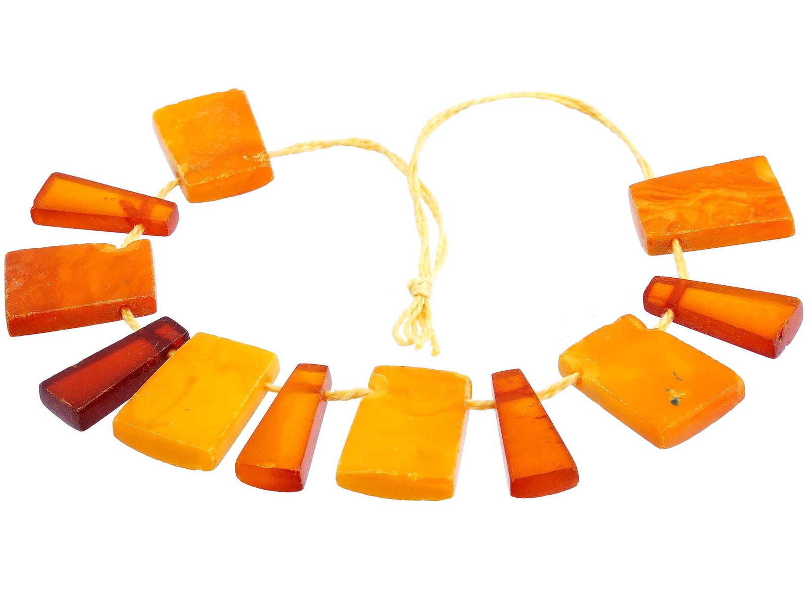 VINTAGE NATURAL AMBER STONE BEADED NECKLACE: A vintage natural amber stone beaded necklace. A total of 11 beads. The beads are mostly rectangular and translucent in shape, with some having a more trapezoidal design. The beads vary in shade from 