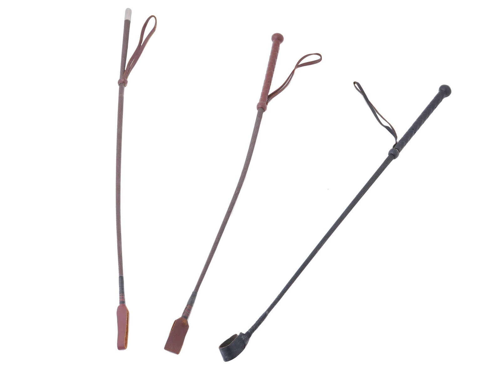 THREE VINTAGE ENGLISH LEATHER EEGEE WHIPS FOR HORSES: A group of three vintage English leather Eegee whips for horses. These whips offer a tangible link to the art of horseback riding and the refined craftsmanship that once accompanied it. The Eegee name