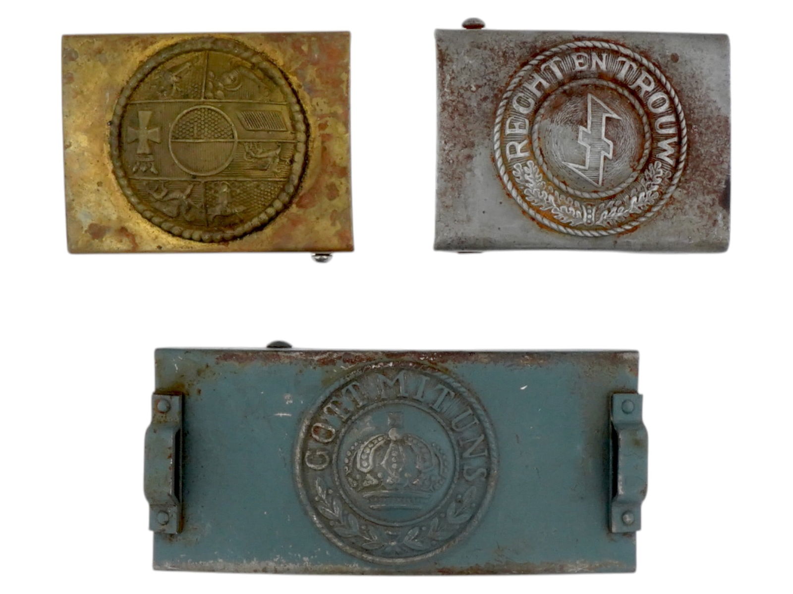 LOT OF THREE WWI GERMAN BAVARIAN BELT BUCKLES: A lot of three WWI German Bavarian belt buckles. The first buckle is a gold toned brass with a circular design featuring a detailed cross and several other symbols within a circle. The second buckle i