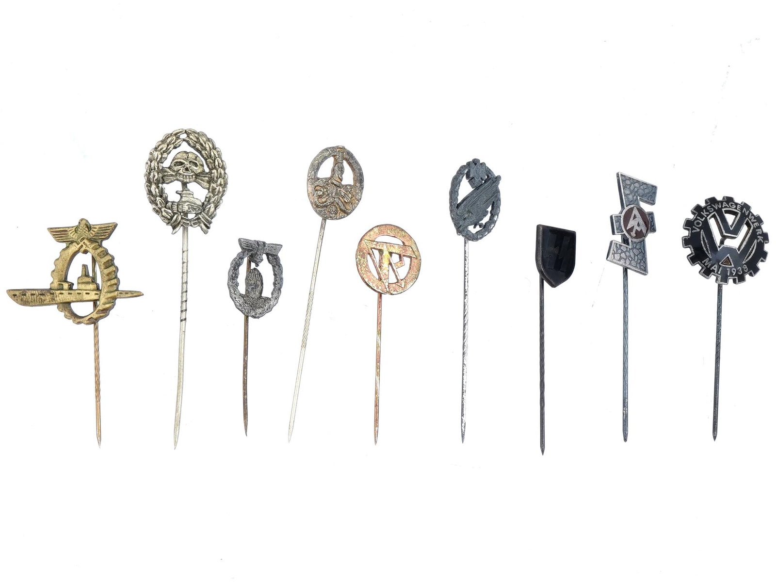 GROUP OF 9 WWII NAZI GERMAN METAL LAPEL STICK PINS: A group of World War II Nazi German metal lapel stick pins. A total of 9 items including U Boat Submarine Dock Workers stick pin, Condor Legion Tanker pin, Minesweeper stick pin, Anti Partisan stick p