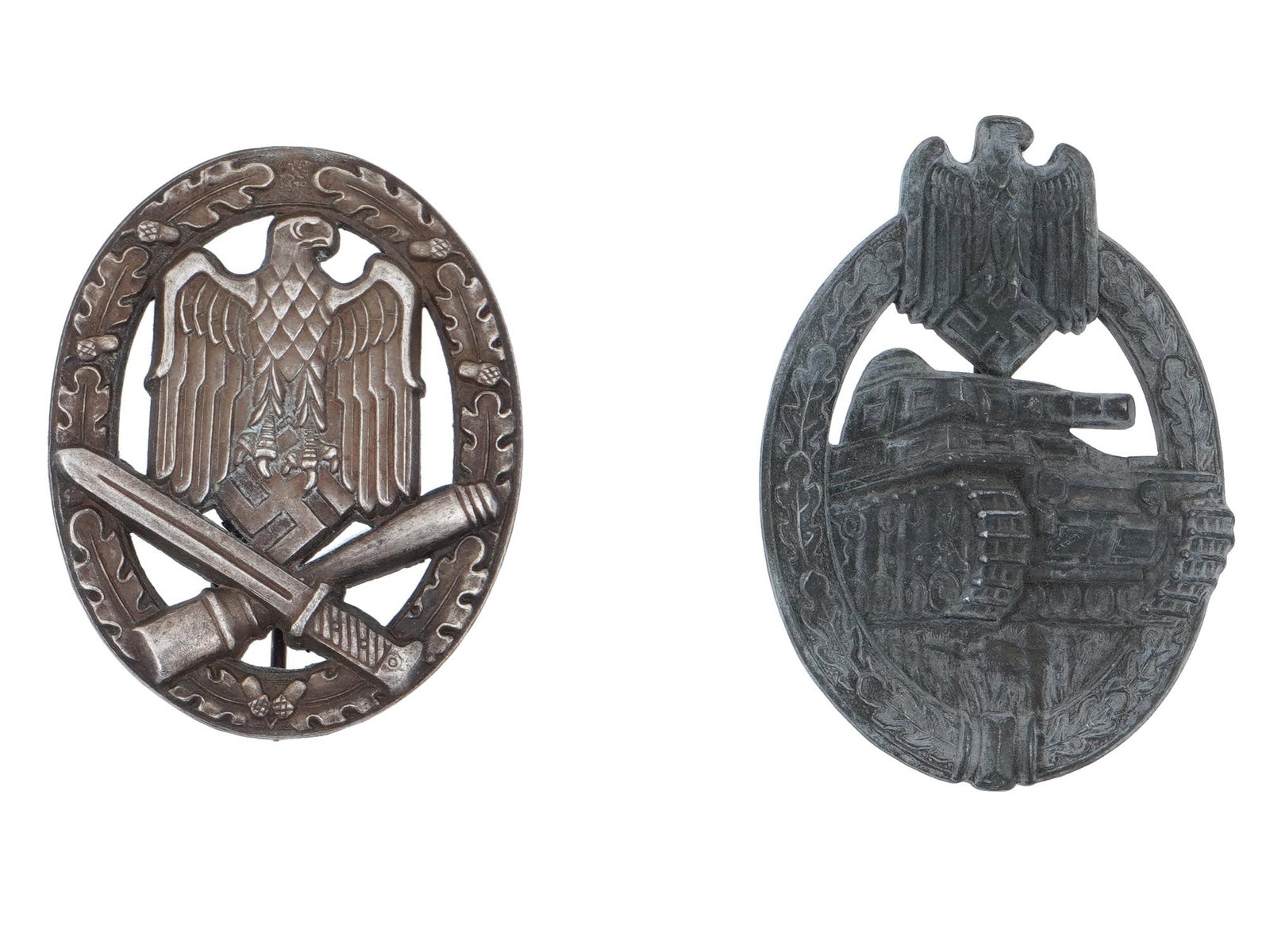 WWII GERMAN MILITARY DECORATIONS ASSAULT BADGES: A pair of World War II Nazi German military decorations, assault badges. The lot includes the General assault badge designed with an eagle holding a swastika above a crossed bayonet and grenade, surro