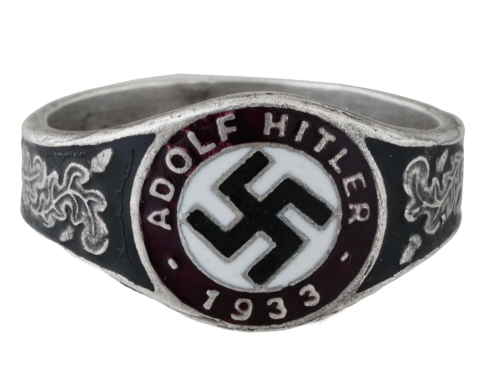 WWII NAZI GERMAN ADOLF HITLER 1933 ELECTION SILVER RING: A WWII Nazi German Third Reich Adolf Hitler 1933 elections silver ring. The exterior of the ring is engraved with oak leaves and covered with black and white enamel with a swastika insignia in the cen