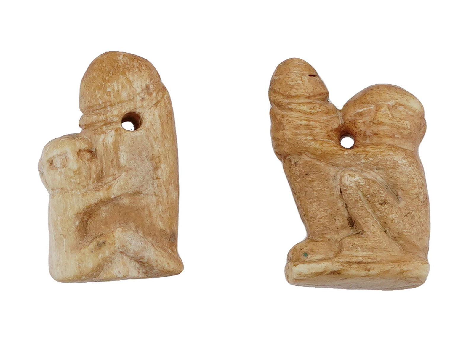 ANCIENT LATE PERIOD EGYPTIAN EROTIC AMULET PENDANTS: A lot of two ancient Egyptian erotic amulet pendants. Circa the Late Period, 700 to 200 BC. The pendants have phallic symbolism associated with the cult of fertility. A through hole for threading a ch