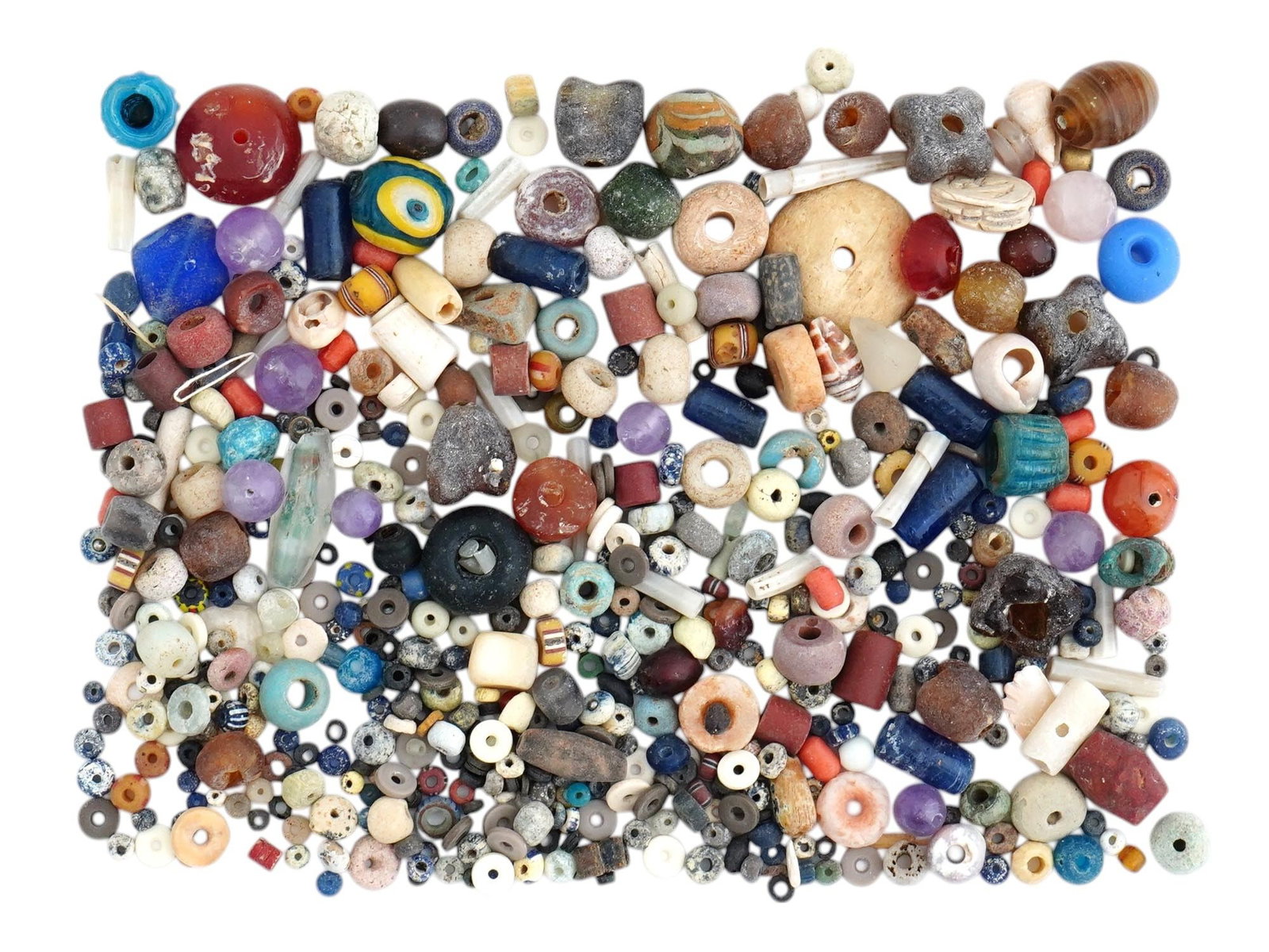 COLLECTION OF ANCIENT GLASS AND STONE BEADS 1000 BC: A large collection of ancient beads, featuring a stunning variety of designs and colors made from Glass, Amethyst, Agate, Garnet, Carnelian, Faience, Shell. Circa 1000 BC and later. This extensive ass