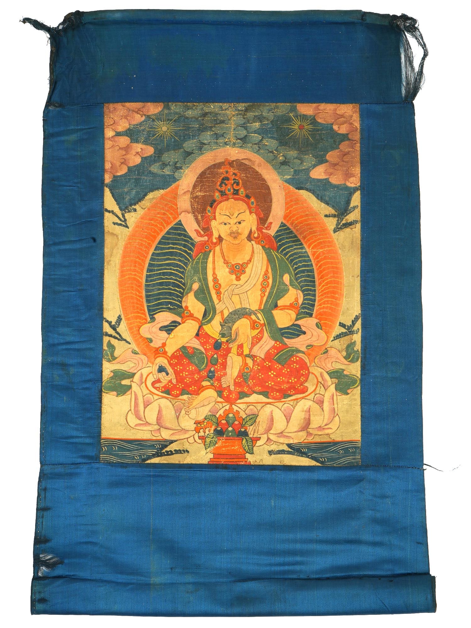 ANTIQUE CHINESE THANGKA PAINTING FROM TIBET GREEN TARA: An antique Chinese thangka painting from Tibet depicting Green Tara rendered in opaque pigments on cloth. The figure is seated on a lotus in a relaxed posture, with one leg extended, symbolizing her r