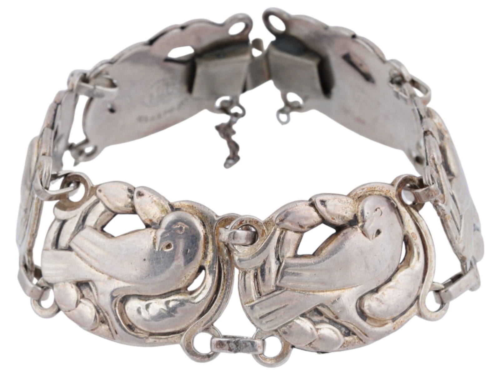 CORO NORSELAND STERLING SILVER BIRD FIGURAL BRACELET: A vintage Coro Norseland Sterling Silver figural bracelet. The bracelet is made in a link design. Each link is adorned with a detailed repousse bird design. Marked, Norseland by Coro Sterling Reg. Us.