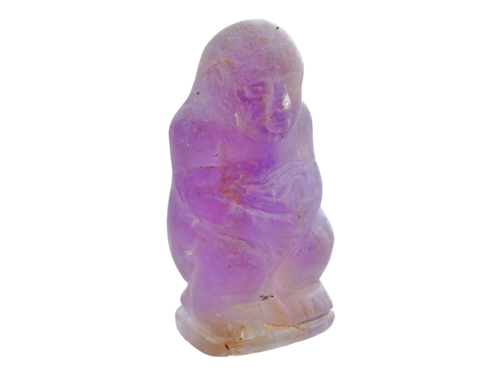 MESOAMERICAN CARVED AMETHYST SITTING HUMAN FIGURE: A Mesoamerican culture archaeological piece featuring a carved amethyst sitting human figure. Crafted with meticulous detail, this artifact represents the artistry and craftsmanship of ancient Mesoame