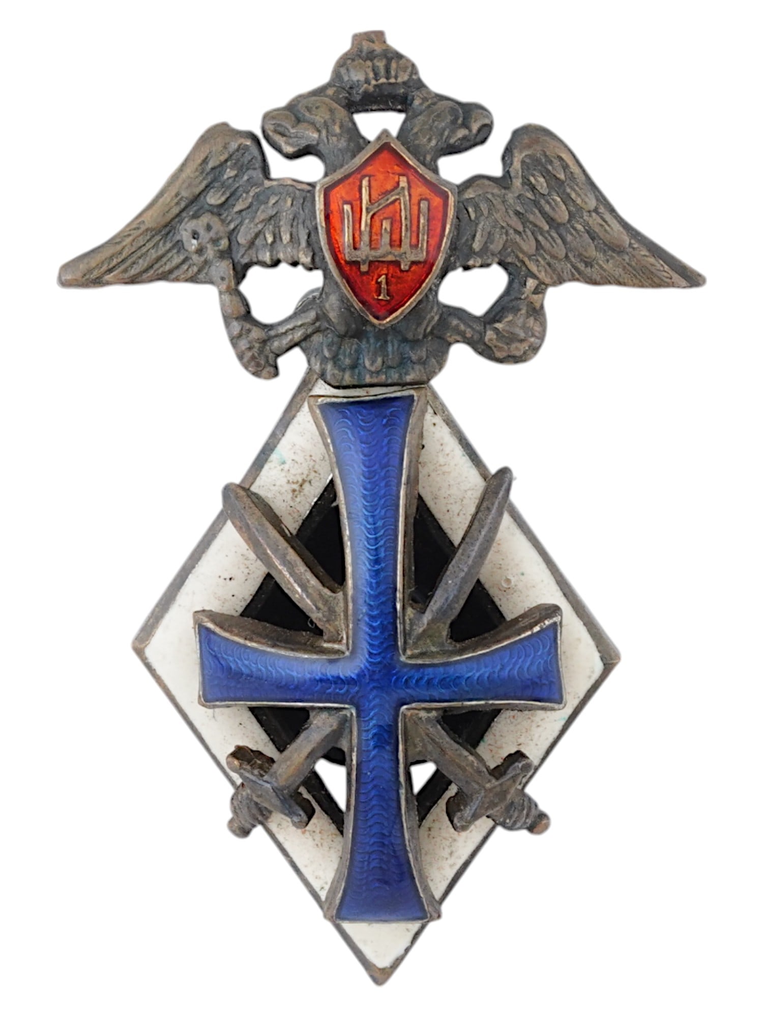 RUSSIAN BADGE OF 1ST PETERHOF SCHOOL WARRANT OFFICERS: An antique Russian, Provisional Government, circa 1917 bronze badge of graduation from the 1st Peterhof school of warrant officers. Featuring a double headed eagle at the top, with a red shield on its
