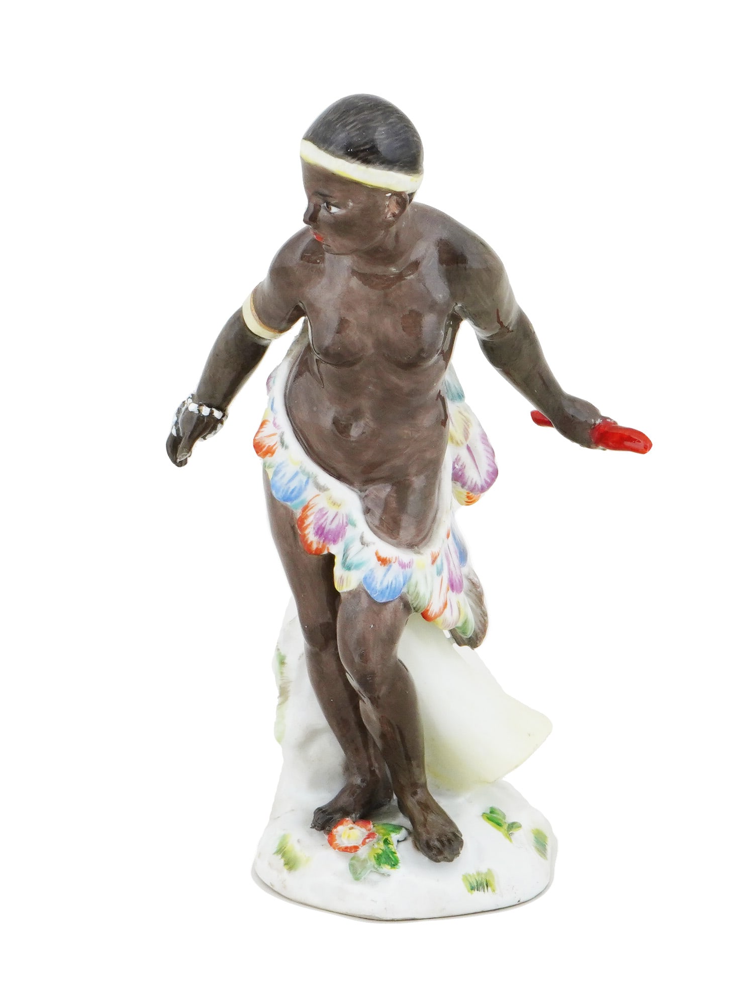 ANTIQUE 19TH C MEISSEN PORCELAIN AFRICAN FEMALE FIGURE: An antique 19th century Meissen porcelain figurine of an African female. The figure is wearing a white headband, bracelet and a skirt of colorful stylized feathers. The figurine stands on a decorative