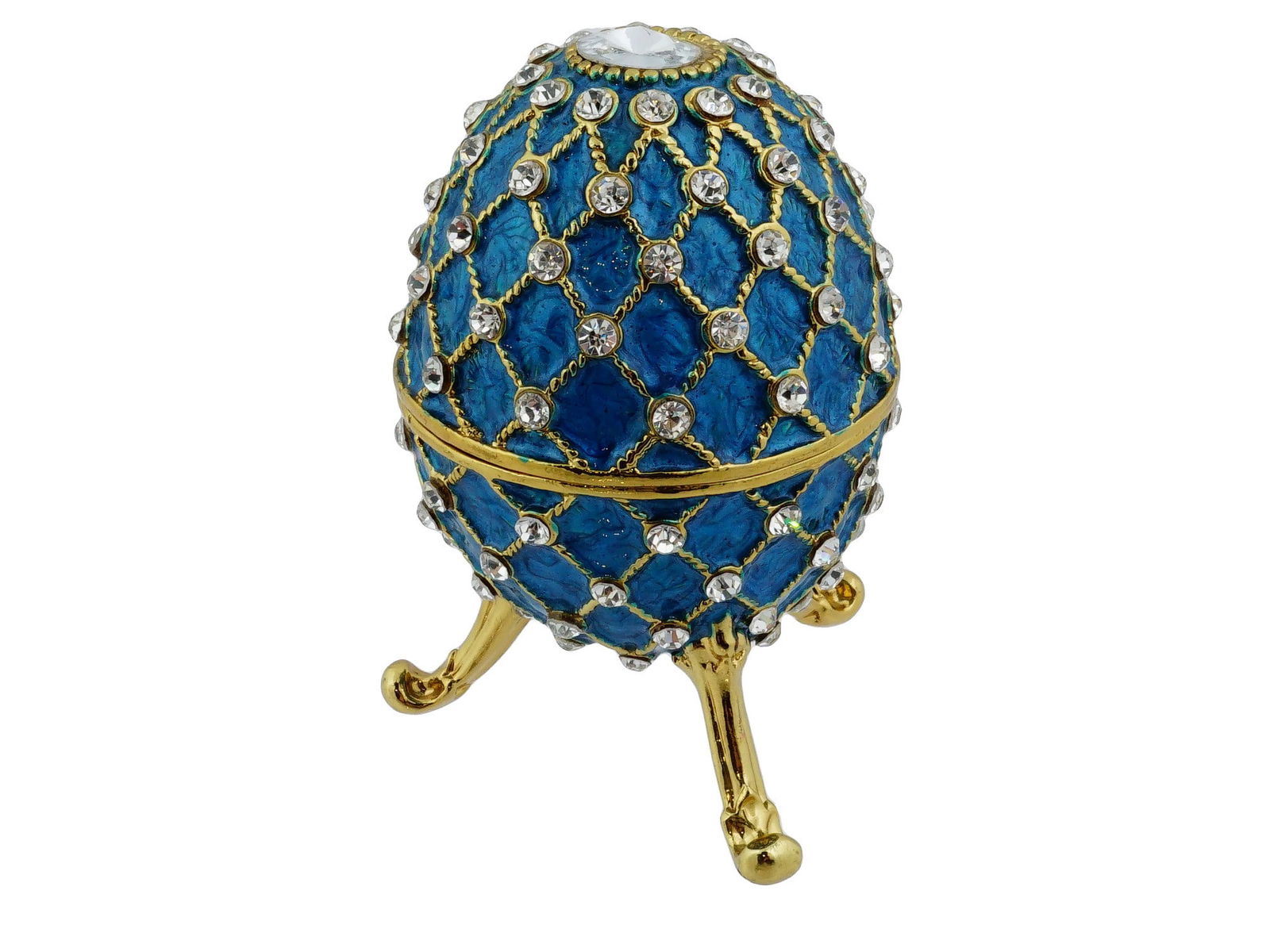 VINTAGE GILT ENAMEL EASTER EGG BOX W CUBIC ZIRCONIA: A vintage gilt enamel Easter egg box with cubic zirconia. The case is separated into two fastened halves. The decorative egg, raised on three legs, is covered with blue enamel and decorated with a mes