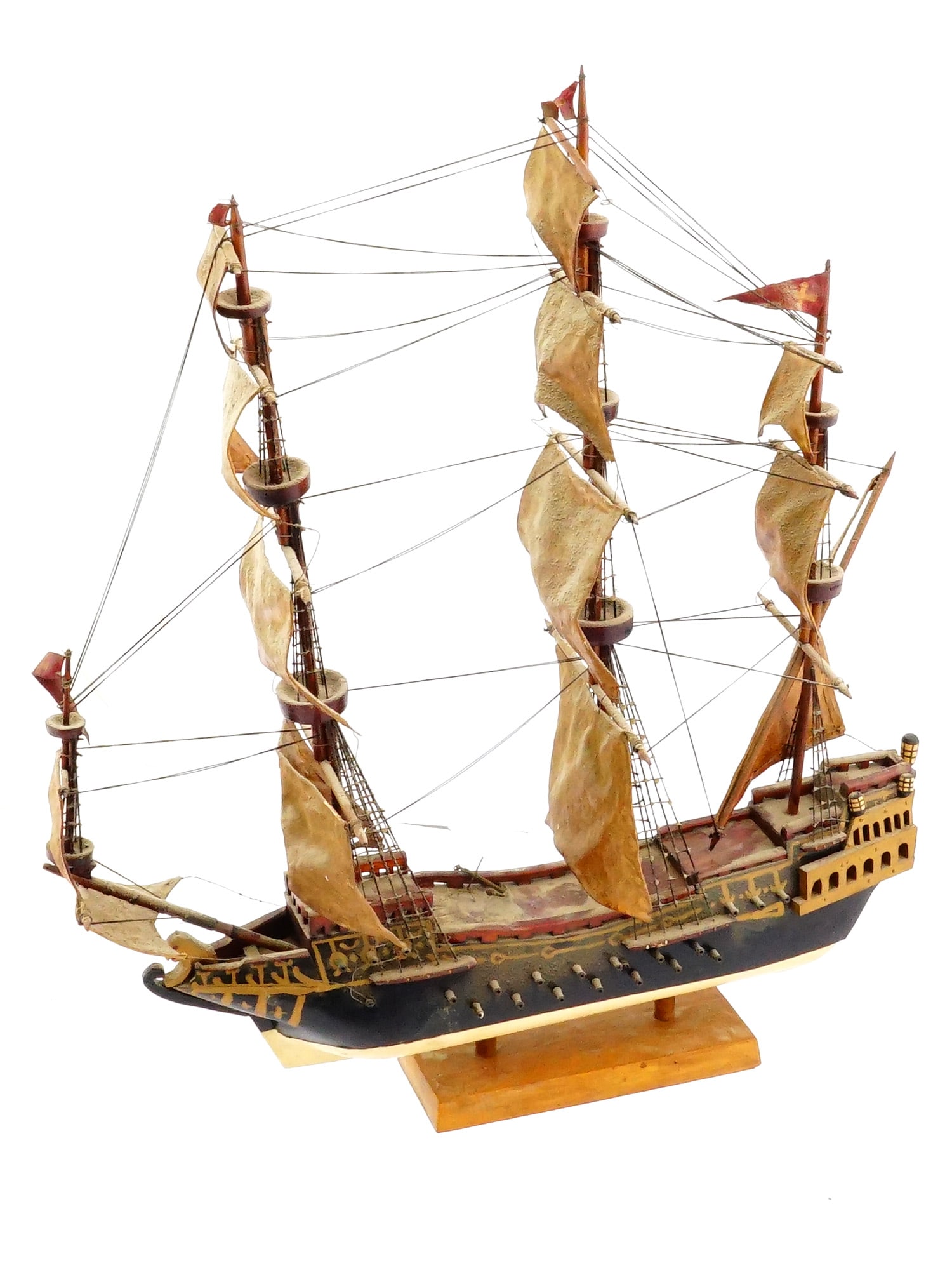 SMALL VINTAGE NAUTICAL HAND MADE WOODEN SHIP MODEL: A small vintage Nautical hand made wooden ship model. The model presents a ship design, highlighted by detailed craftsmanship including realistic sails and ornamental elements. The ship is mounted on