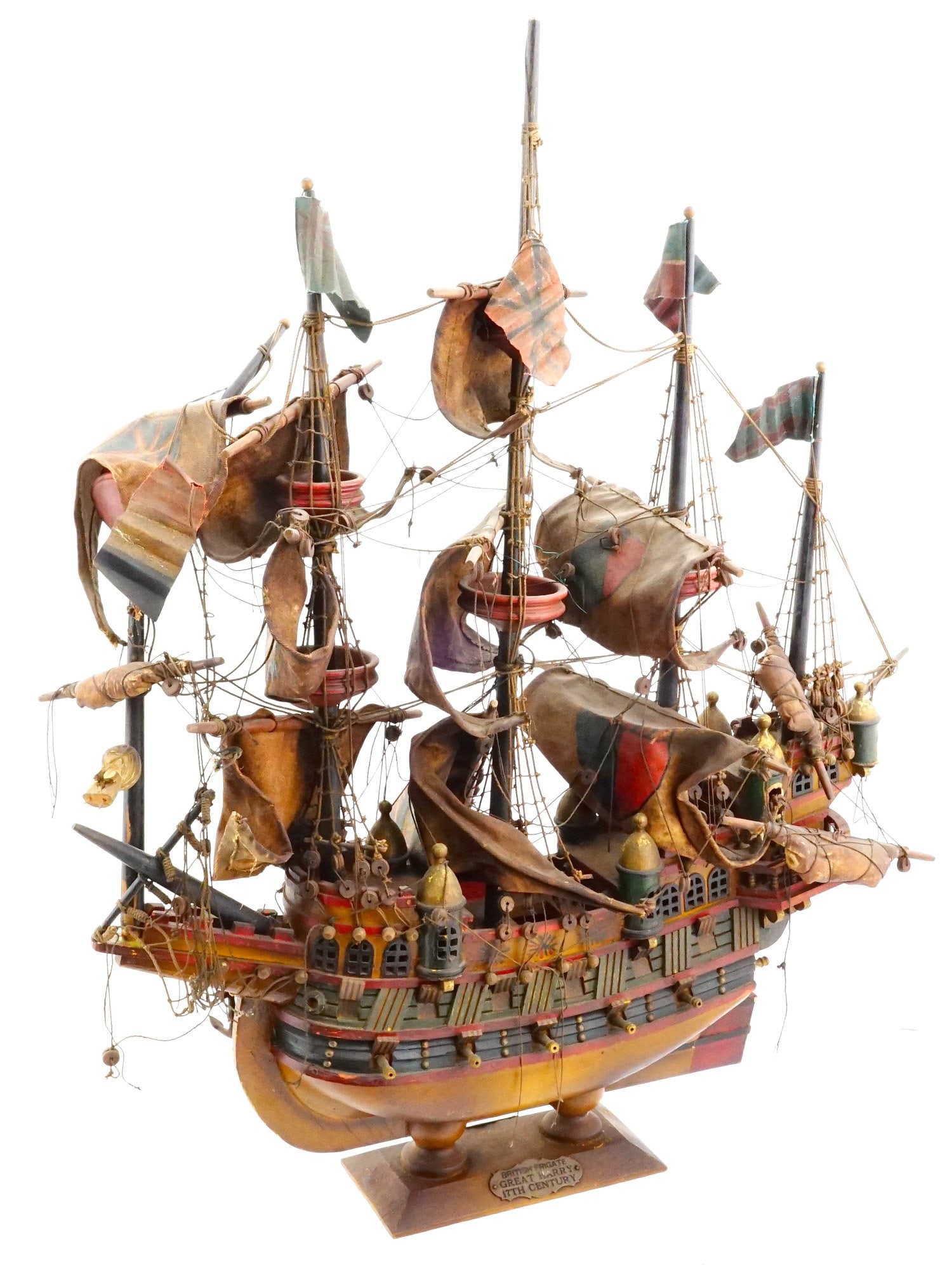 17TH CEN BRITISH FRIGATE HAND MADE WOOD SHIP MODEL: A vintage hand made ship model of the 17th century British Frigate Great Harry. The ship is adorned with colorful sails, including a lion emblem on one of the flags, standing as a symbol of British ma