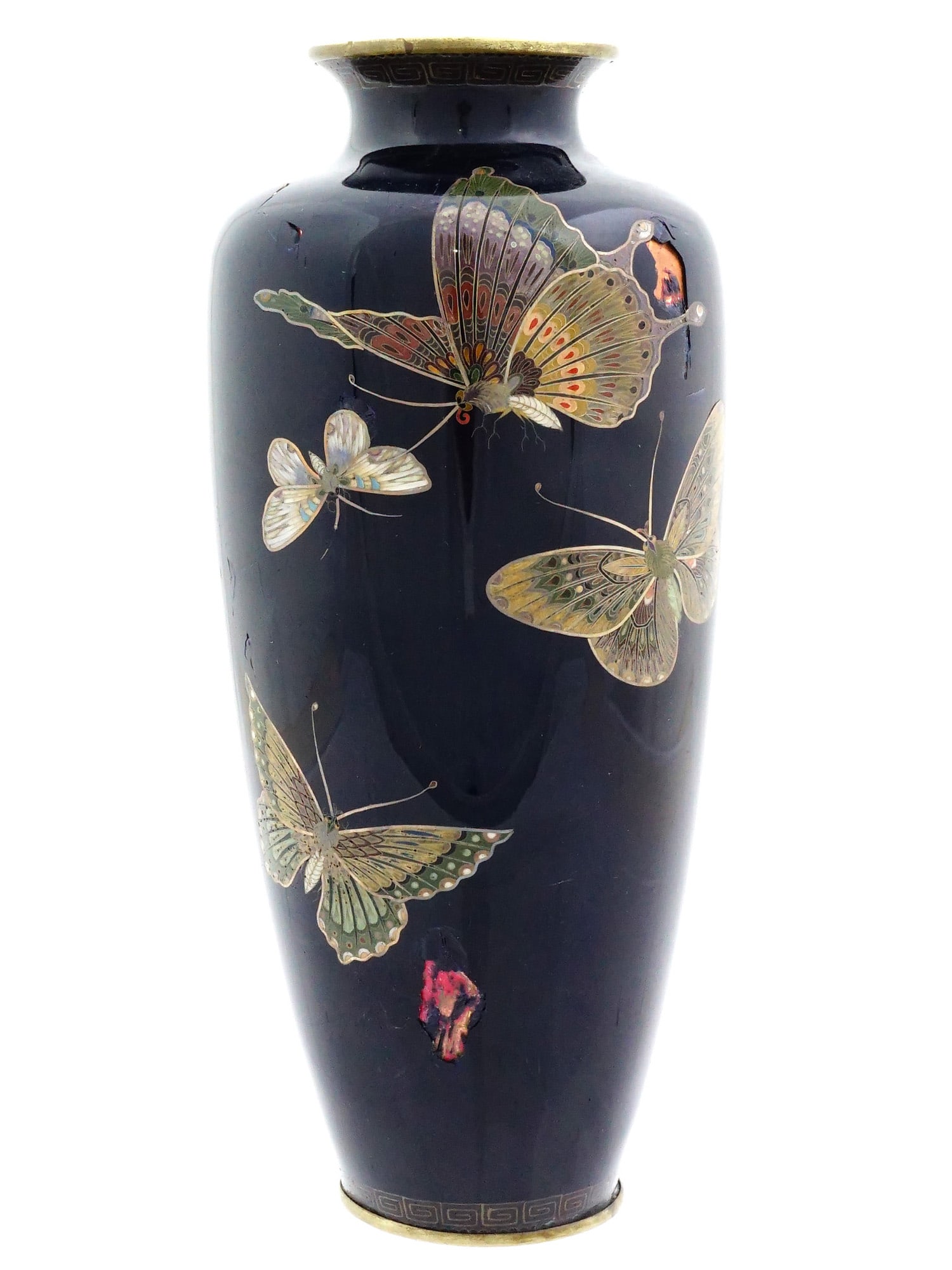JAPANESE BUTTERFLY CLOISONNE ENAMEL OVER COPPER VASE: A Japanese enamel over copper vase. The vase has an urn shaped body and a wide neck with a fluted mouth. The vase is enameled with a polychrome design representing butterflies made in the Cloisonne te