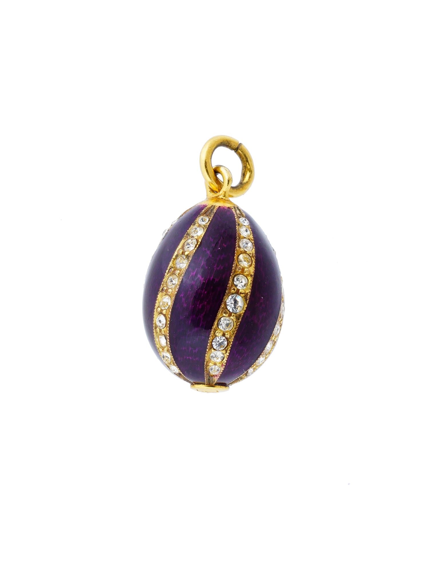 RUSSIAN GILT SILVER GUILLOCHE ENAMEL EGG PENDANT: A Russian gilt silver egg-shaped pendant. Purple guilloche enamel surface, stripe motif set with crystals. There is a relief monogram on the bottom. Traces of a silver standard mark and makers mark ar
