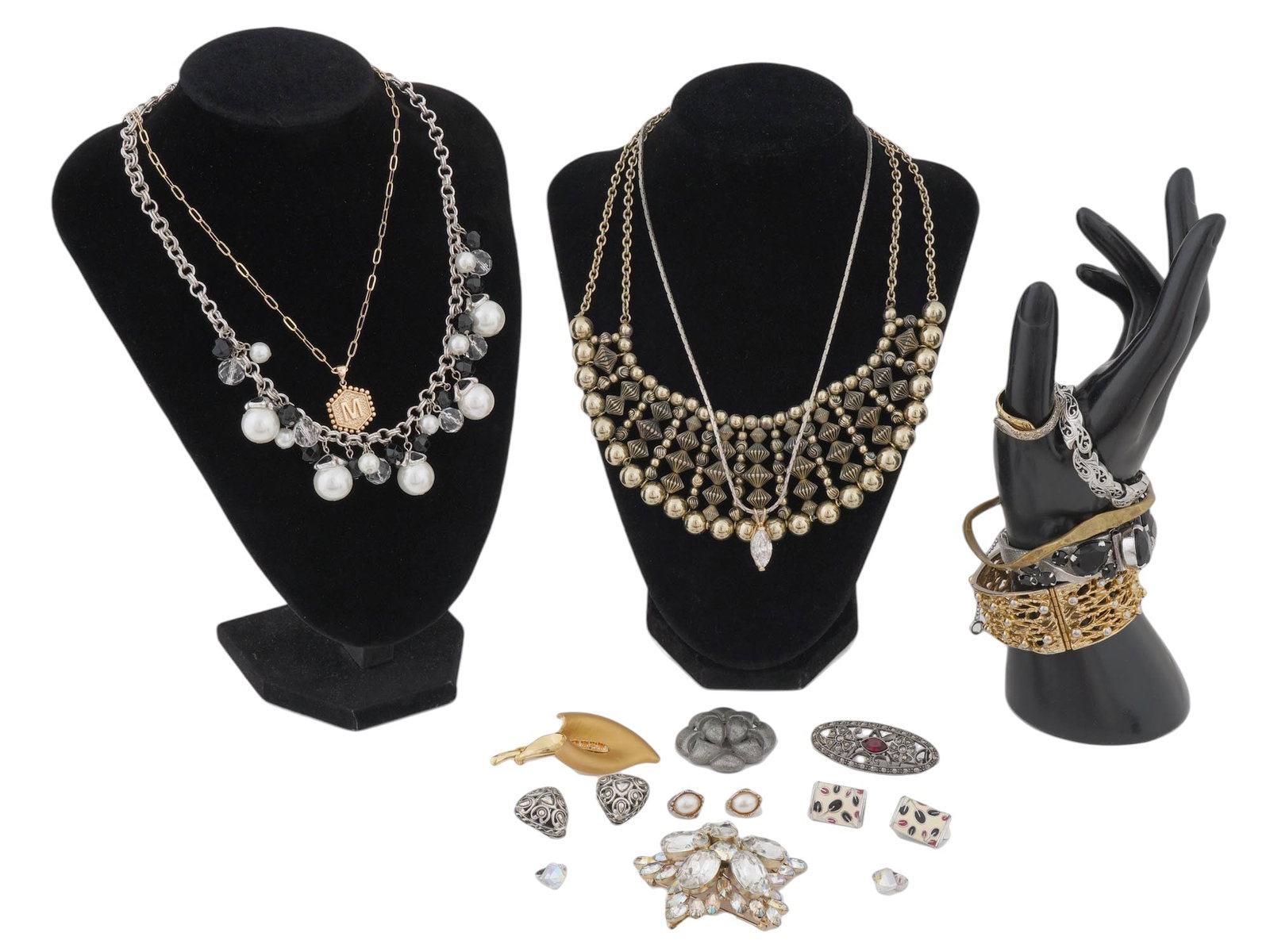 COLLECTION COSTUME JEWELRY WITH VARIOUS DESIGN: A collection of costume jewelry. A group of necklaces including a necklace with faux pearls and black beads, and a necklace with a pendant featuring a letter M. The other features a bolder, bib style 