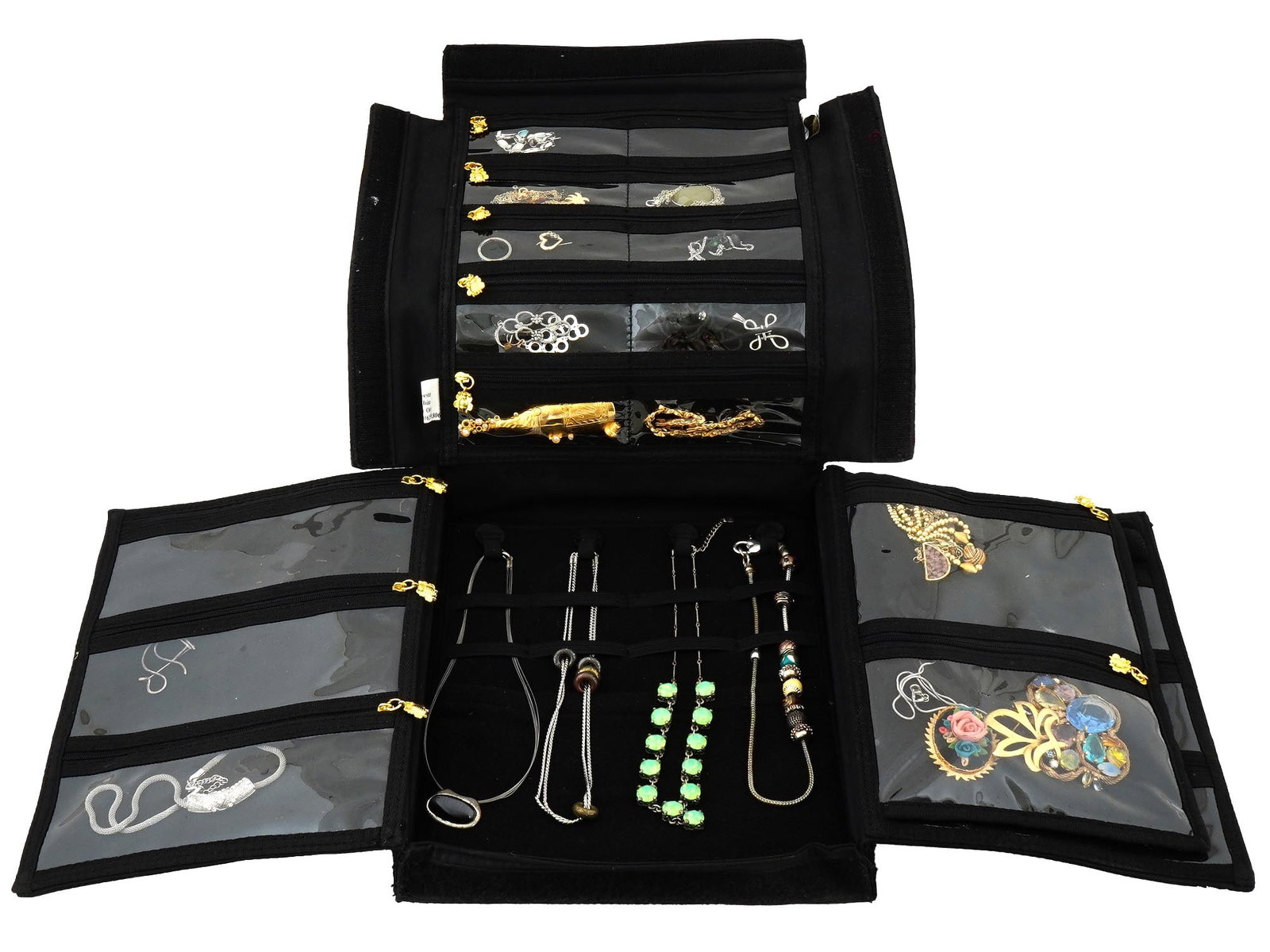 BLACK EMBROIDERED CASE WITH COLLECTION OF JEWELRY: A black jewelry case displaying a variety of jewelry. The case is divided into multiple compartments and sections designed to hold different types of jewelry. The top flap has clear plastic pockets wi