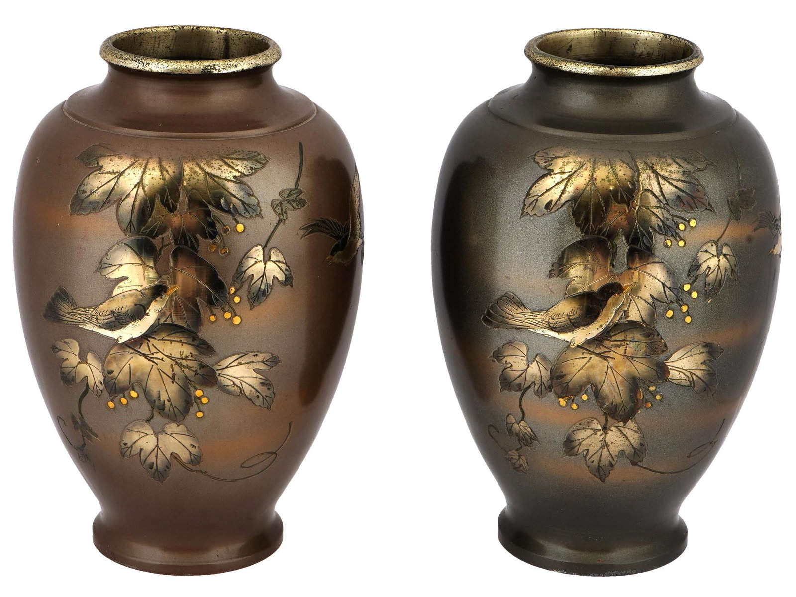 PAIR OF VINTAGE JAPANESE GILT VASES WITH BIRDS: A pair of vintage Japanese gilt vases with birds. Almost identical vases with differences in shade, rounded wide shape with slightly narrowed necks. Raised on a low base. Both vases depict a forest bi