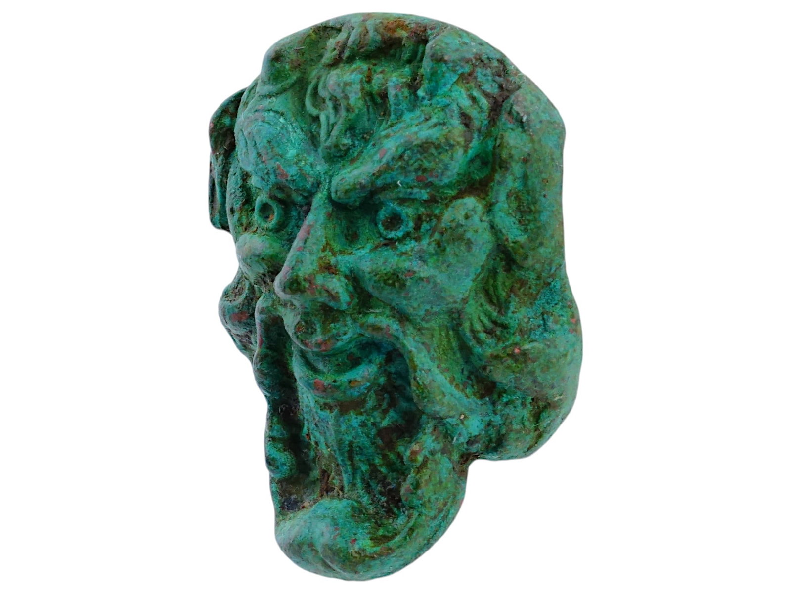 NEAR EAST BRONZE HEAD OF DEMON PAZUZU: A Near East bronze head of Pazuzu. Pazuzu, a demon in Mesopotamian mythology, is depicted with a fierce expression, including bulging eyes, a prominent nose, and a stylized beard. The bronze has a gre