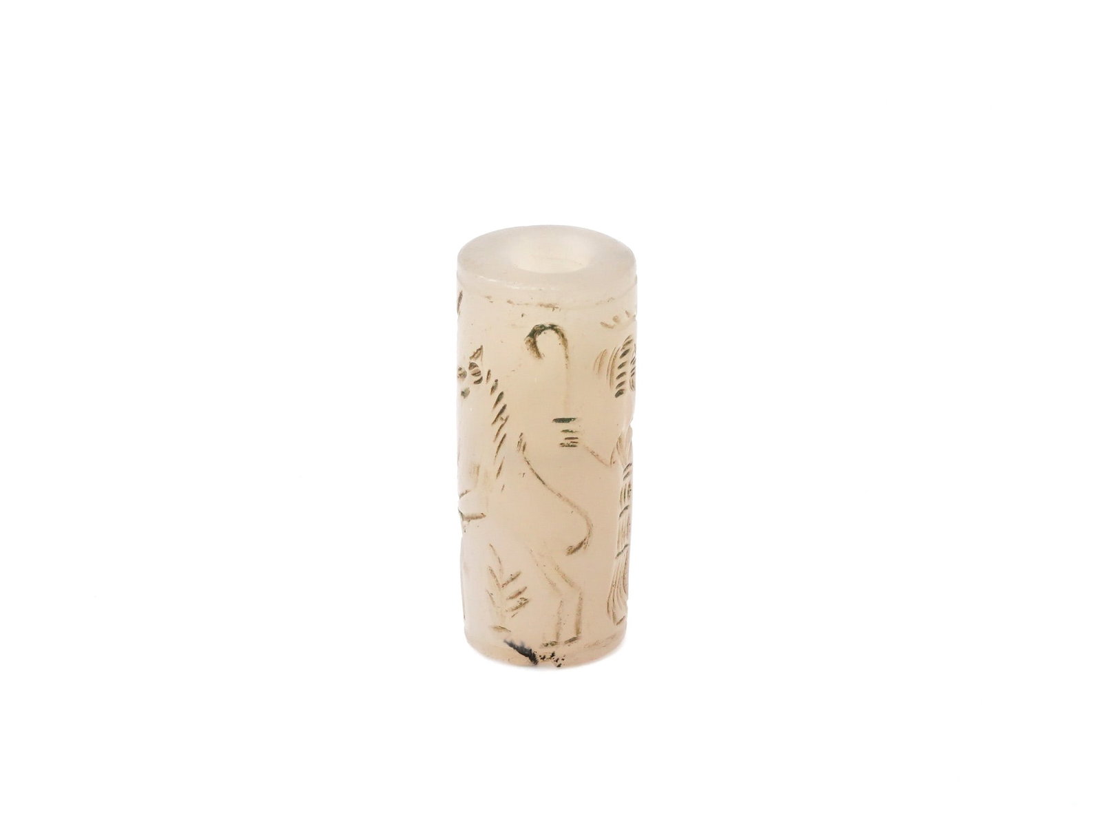 ANCIENT NEAR EASTERN CARVED STONE CYLINDER SEAL: An ancient Near Eastern carved stone cylinder seal showing human and animal figures. Cylinder seals were widely used in the ancient Near East as a form of personal identification and a means of authen