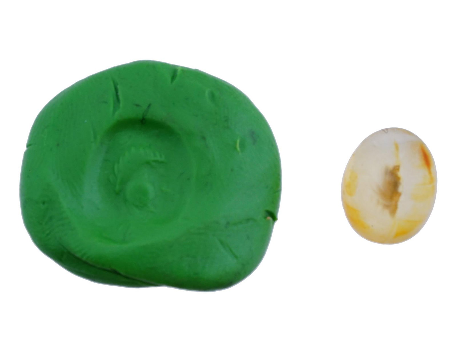 CARVED AGATE INTAGLIO WITH ANCIENT ROMAN IMAGE: A carved agate intaglio featuring a detailed ancient Roman image from classical mythology. Such pieces were often used as personal seals, amulets, or jewelry. Roman Carvings And Intaglio Collectibles.