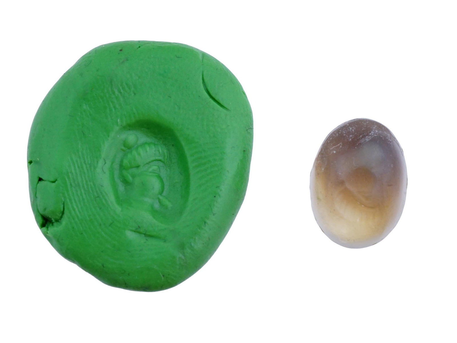 CARVED AGATE INTAGLIO WITH ANCIENT ROMAN IMAGE: A carved agate intaglio featuring a detailed ancient Roman image from classical mythology. Such pieces were often used as personal seals, amulets, or jewelry. Roman Carvings And Intaglio Collectibles.