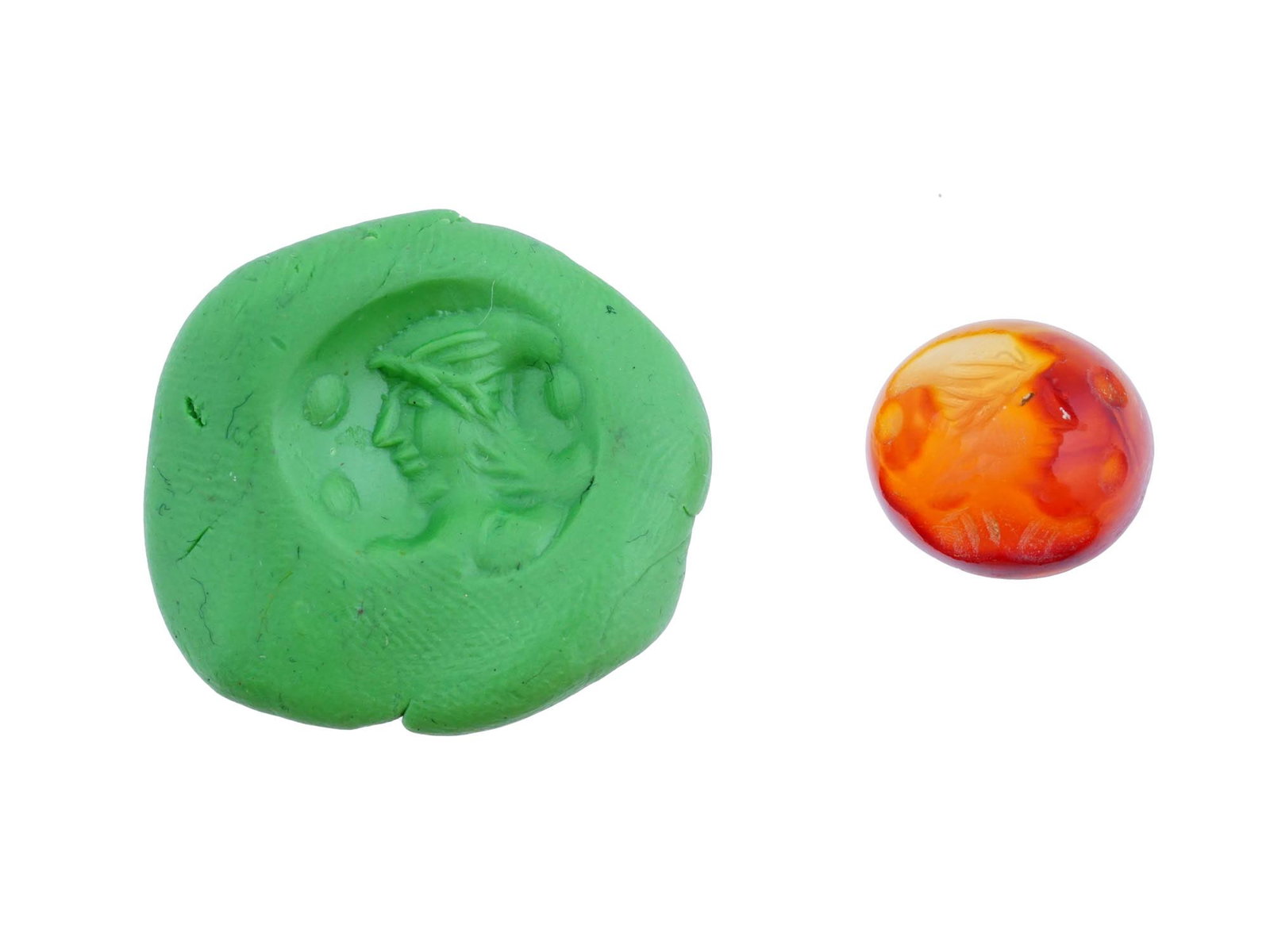 CARVED AGATE INTAGLIO WITH ANCIENT ROMAN PORTRAIT: A carved agate intaglio featuring a detailed ancient Roman depiction of portrait from classical mythology. Such pieces were often used as personal seals, amulets, or jewelry. Roman Carvings And Intagl