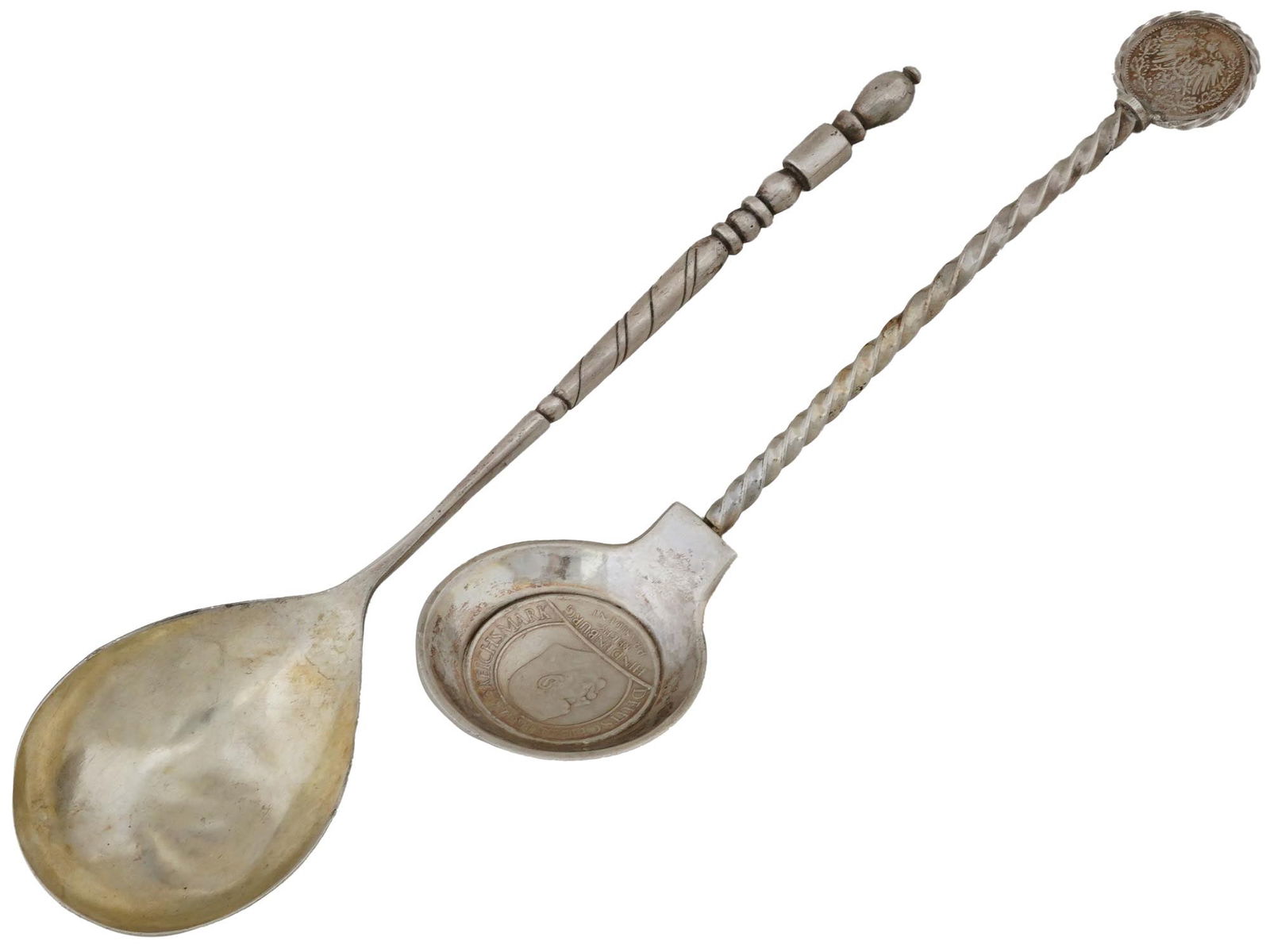 RUSSIAN AND GERMAN ANTIQUE SILVER DECORATIVE SPOONS: A lot of two, Russian and German antique silver decorative spoons. The Russian spoon is adorned with a twisted handle and etched floral and geometric patterns on the back. Marked with a silver standar